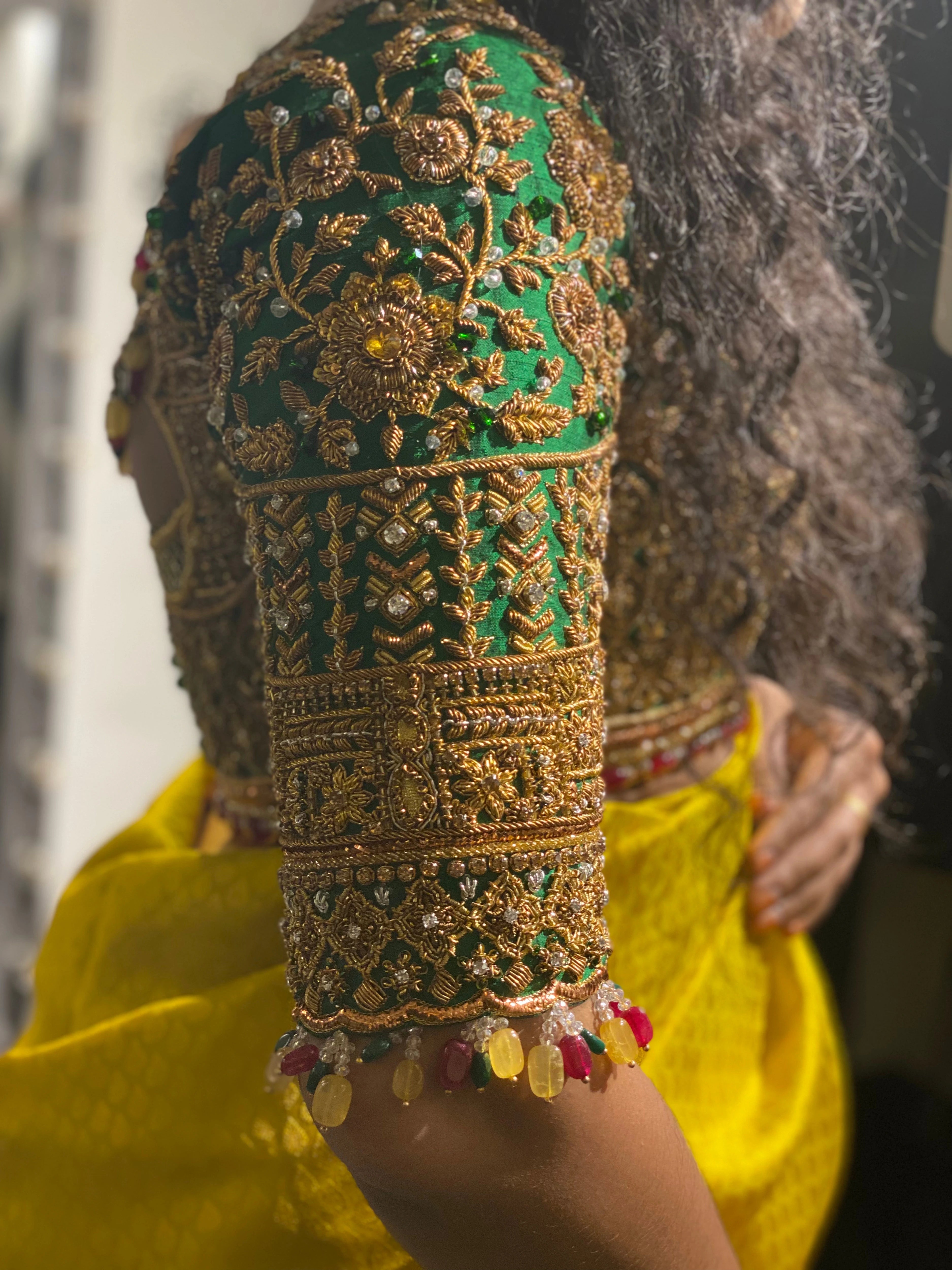 Bride Cris in a bottle green silk blouse handcrafted by team Archana Karthick.