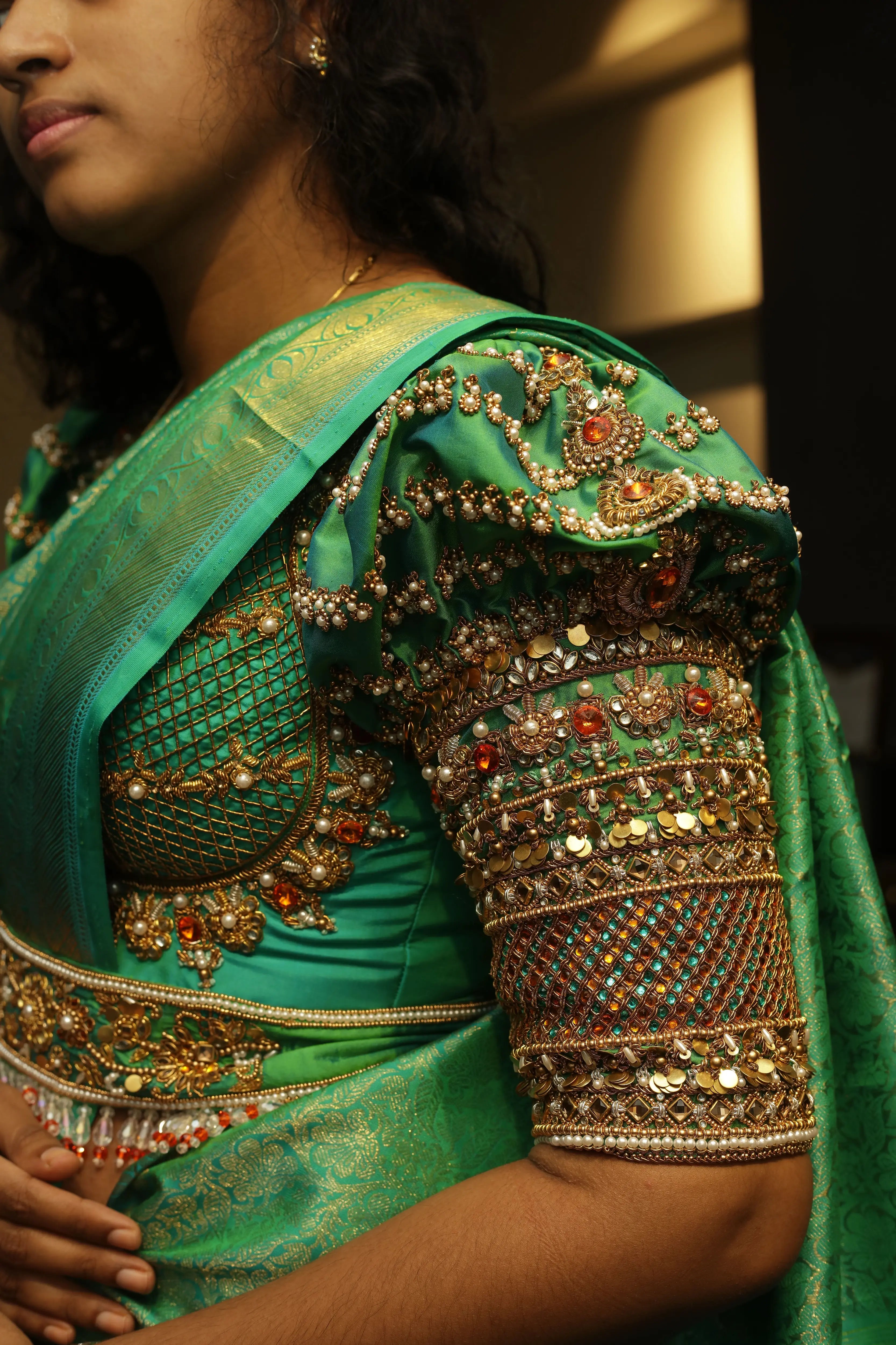 Bride Cris in a sea green puff sleeved silk blouse & belt, tulle veil, handcrafted with appliques, beads, kundan, stones, crystals, etc by team Archana Karthick