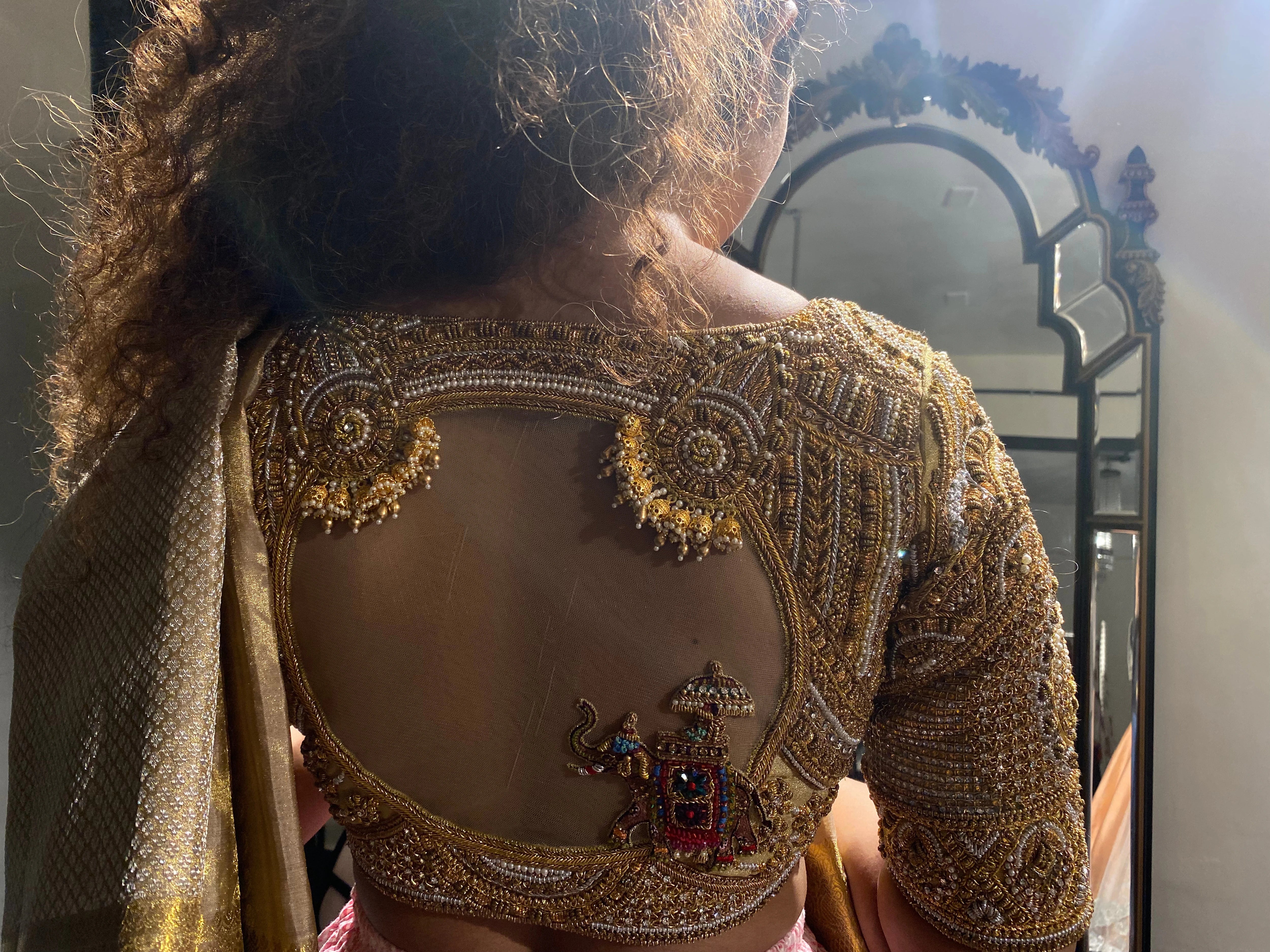 Bride Divya during her fittings in a gold silk blouse handcrafted by team Archana Karthick.