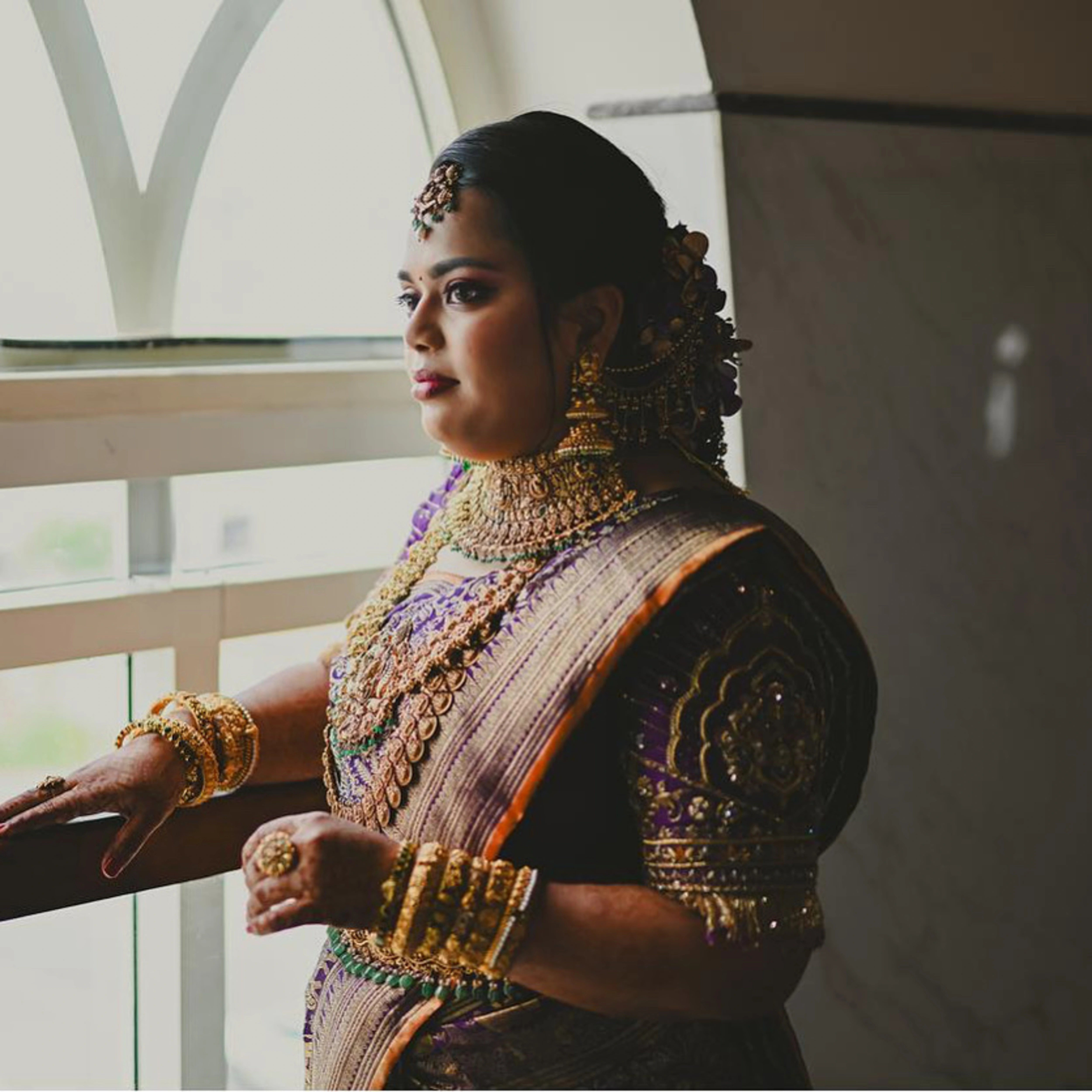 Bride Gayathri for photoshoot in a purple silk blouse by team Archana Karthick.