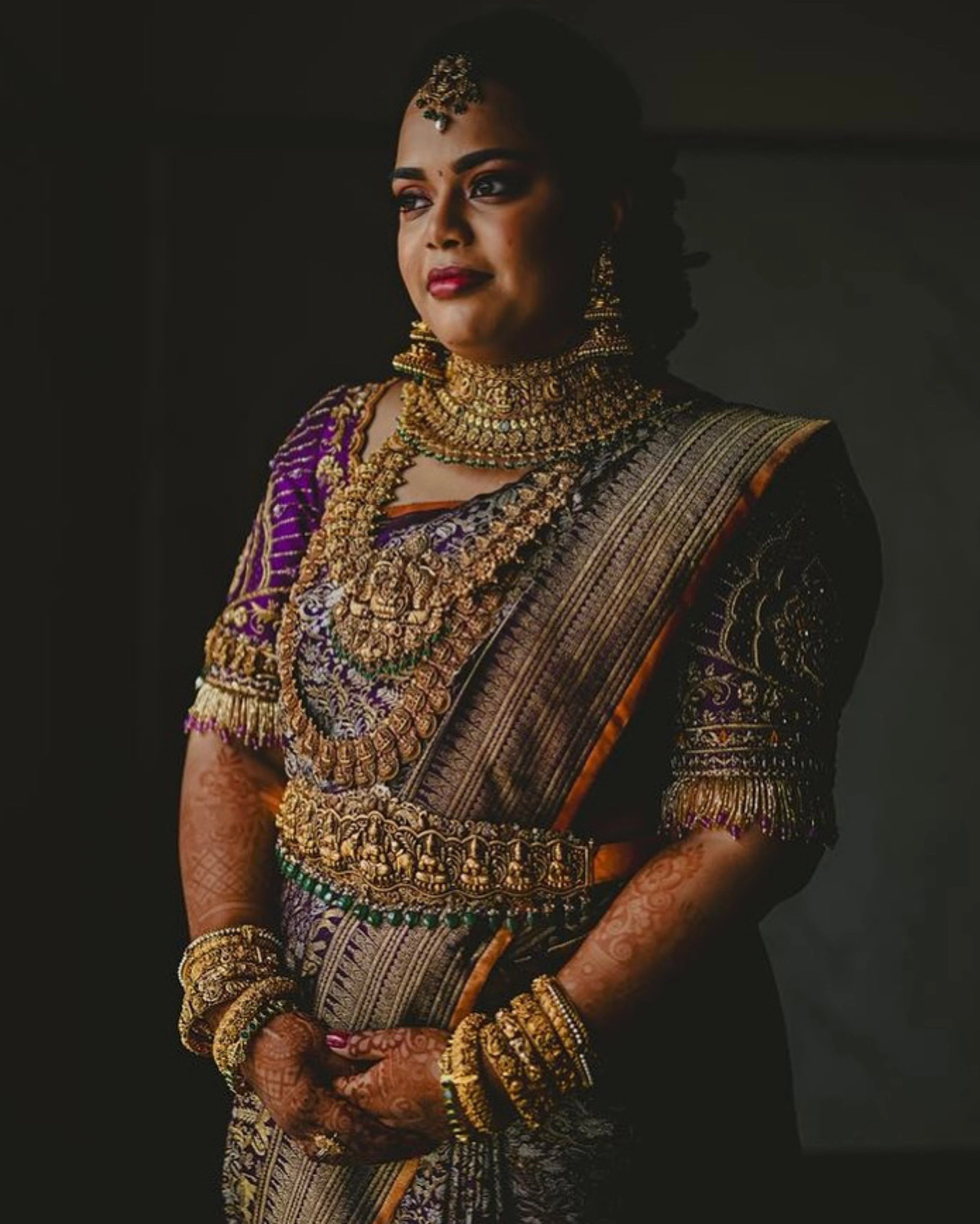 Bride Gayathri in a purple silk blouse by team Archana Karthick.