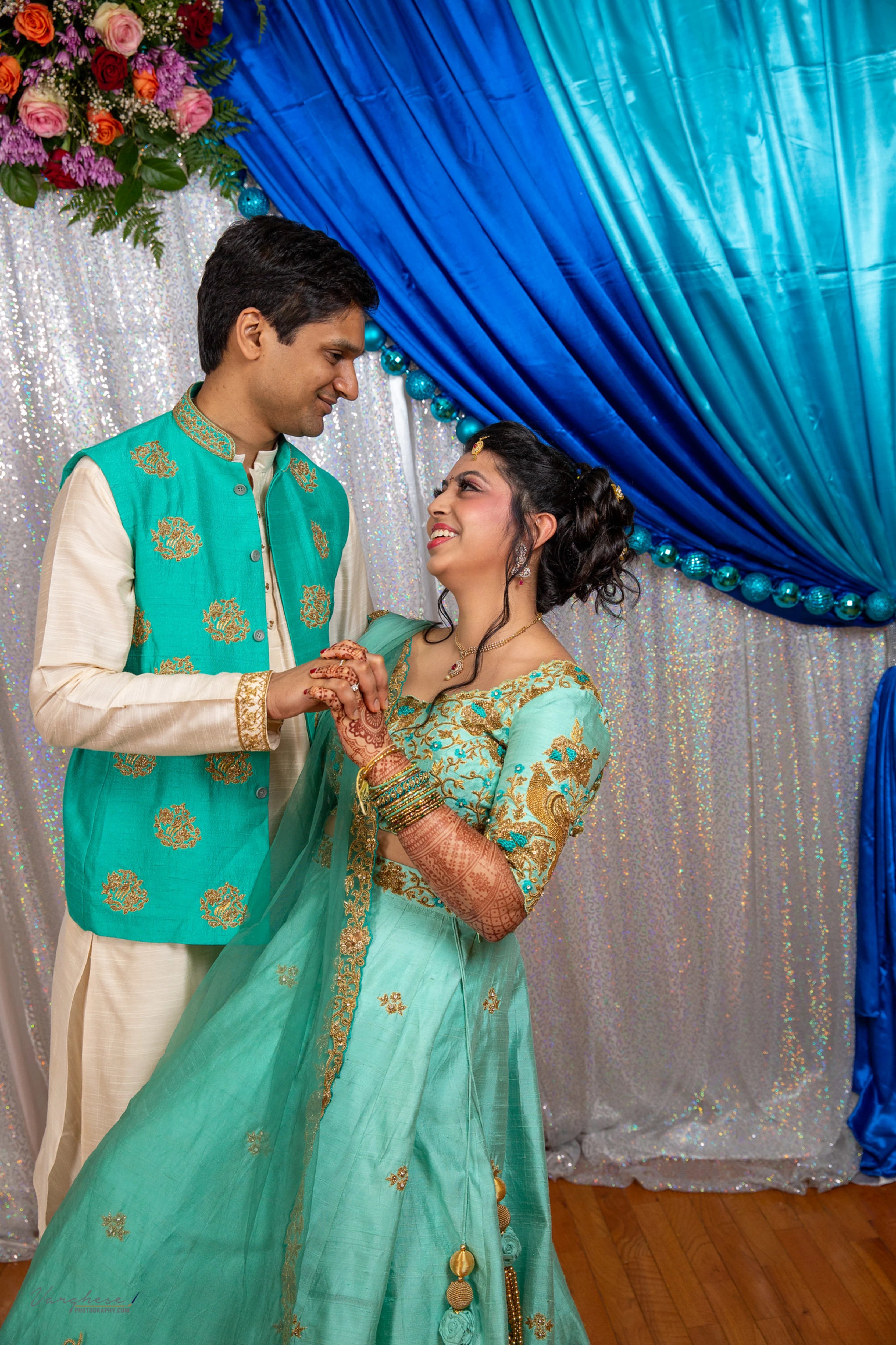 Bride & Groom from Michigan, USA, dancing in a teal raw silk lehenga and bandhgala set, handcrafted by team Archana Karthick.