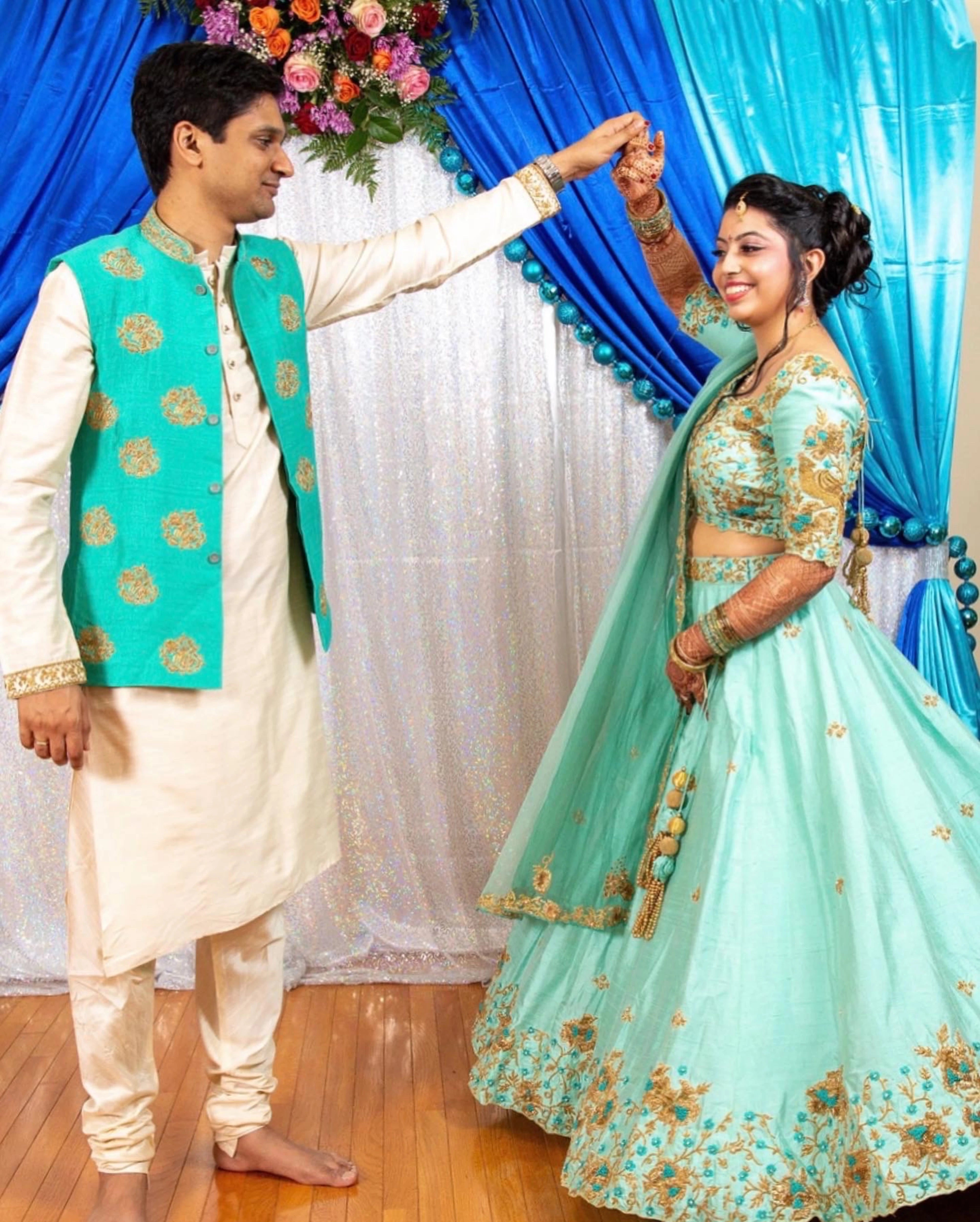 Bride & Groom from Michigan, USA in a teal raw silk lehenga and bandhgala set, handcrafted by team Archana Karthick.