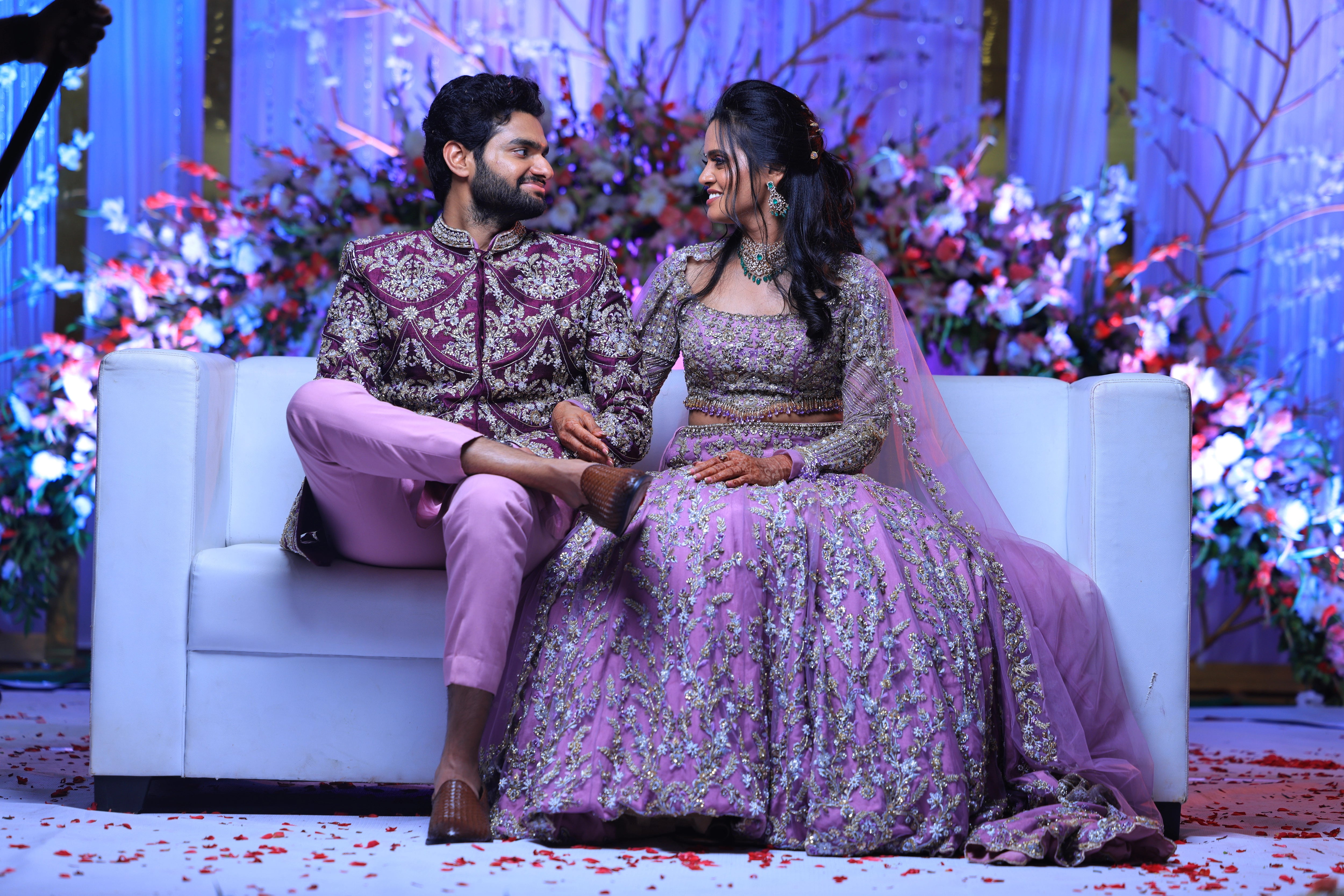 Bride & Groom smiling in lavender raw silk lehenga and sherwani, handcrafted with sequins, cutdana, beads, crystals, rhinestones and zardozi by Archana Karthick