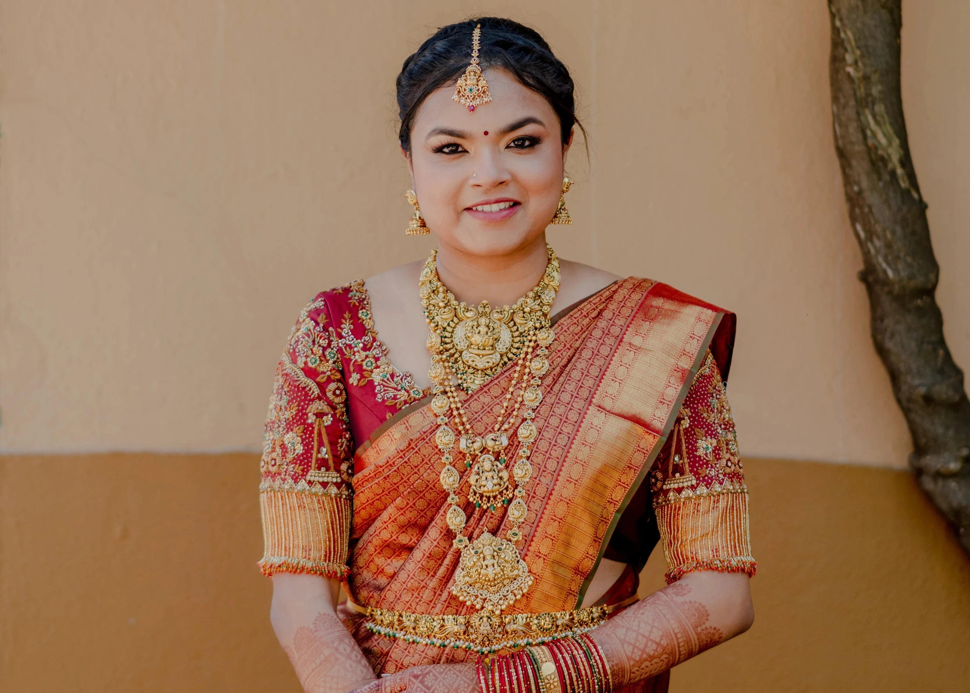 Bride Haripriya in a red silk concept blouse for her wedding, handcrafted with zardozi, resham, stones, beads, crystals and cutdana by team Archana Karthick.