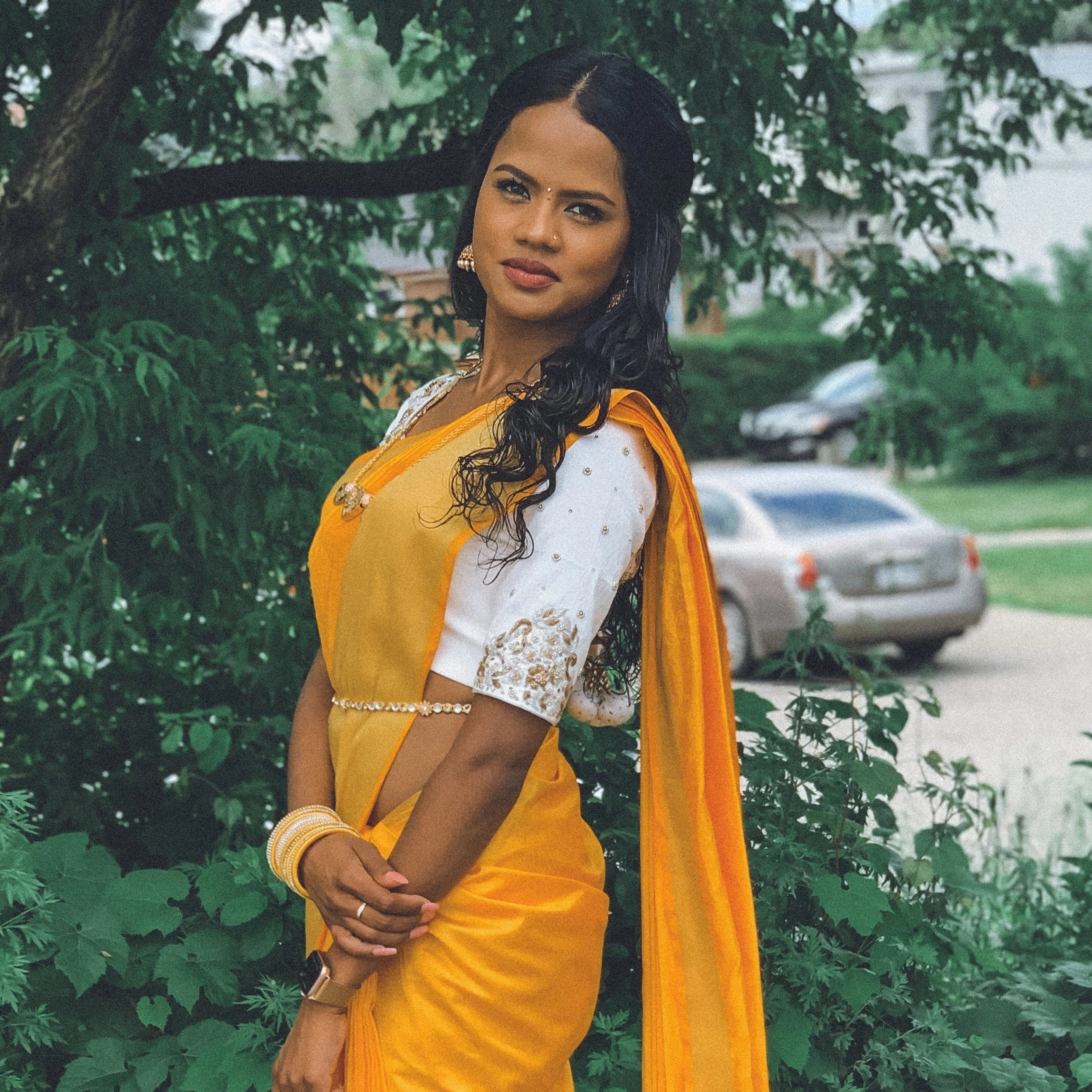 Bride Hemini from Canada, posing in a white raw silk blouse handcrafted by team Archana Karthick.