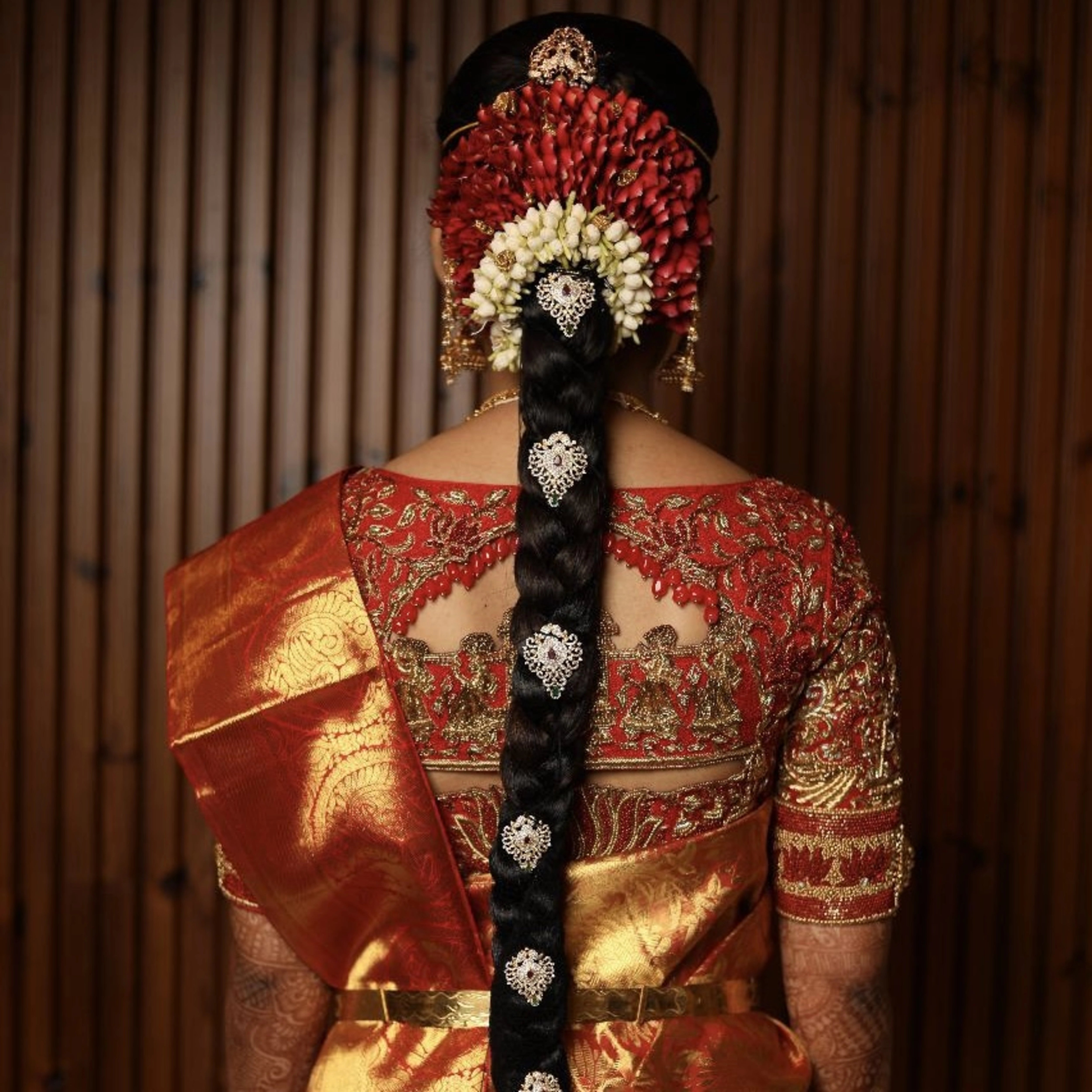 Bride Jashwanti Reddy in a red silk palanquin concept blouse for her wedding, handcrafted with zardozi, resham and beads by team Archana Karthick.