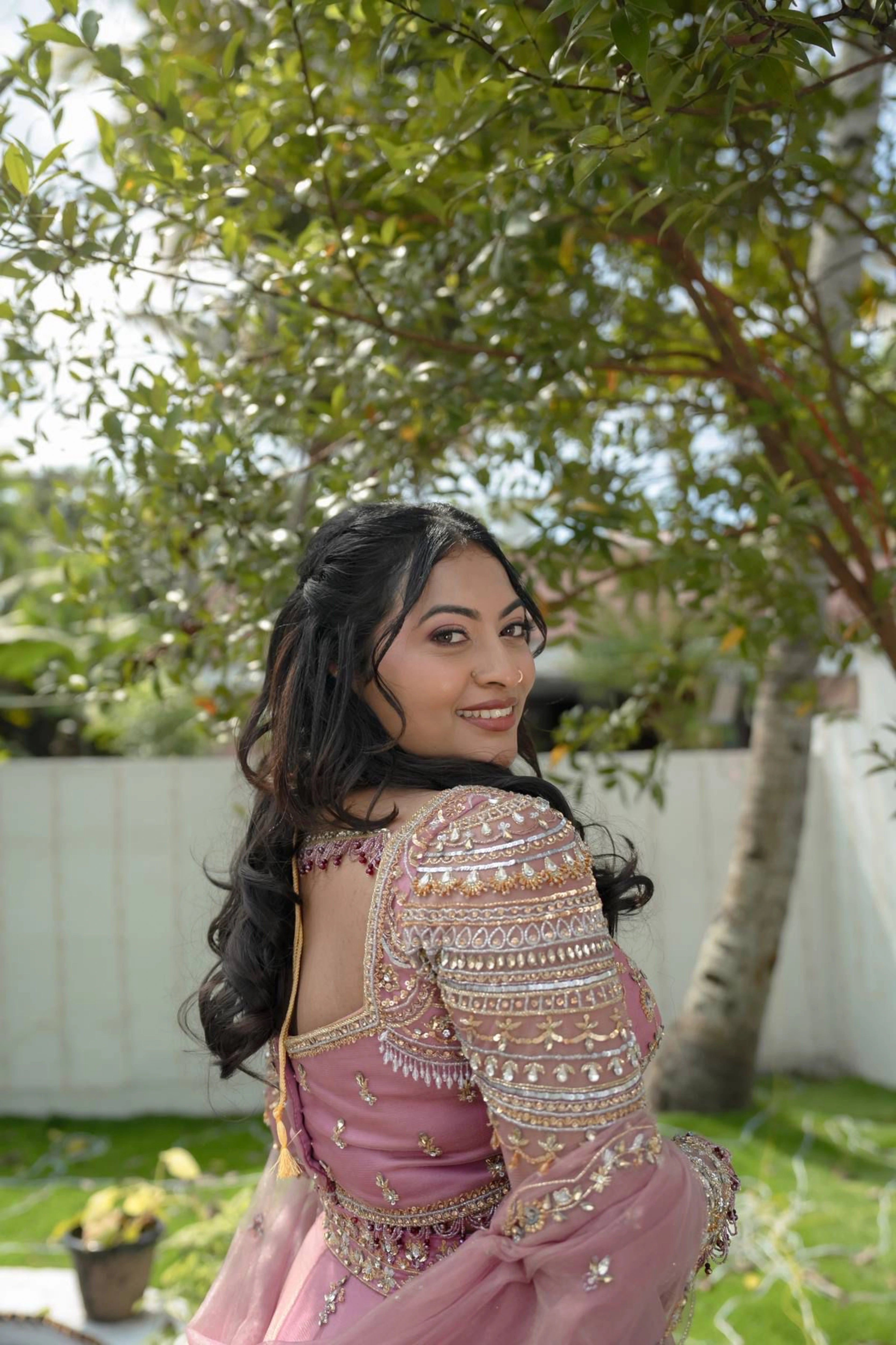 Bride Karoline from Qatar smiling and posing in a lilac tulle lehenga by team Archana Karthick.