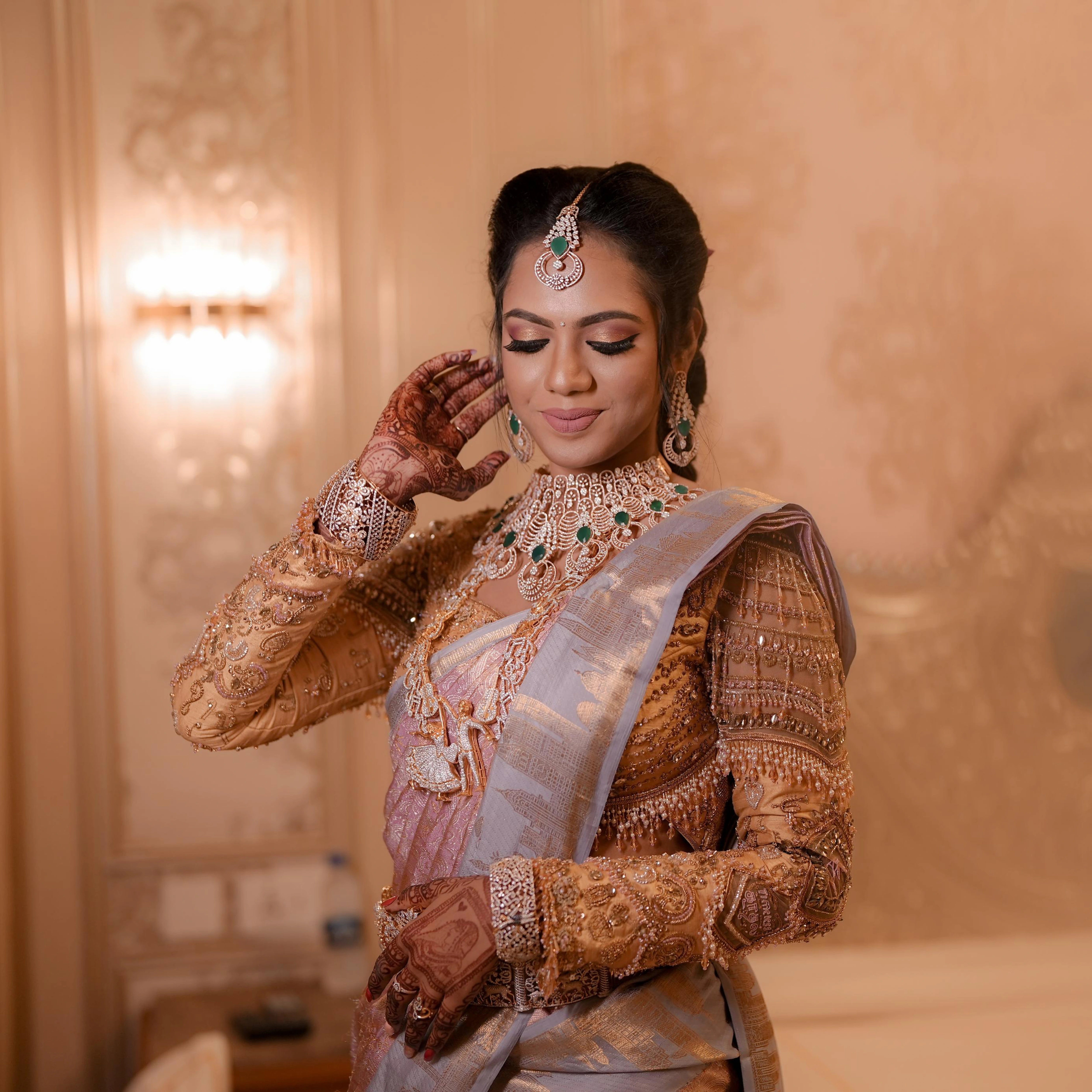 Bride Keerthiga from Chennai in a rose gold silk blouse by team Archana Karthick.
