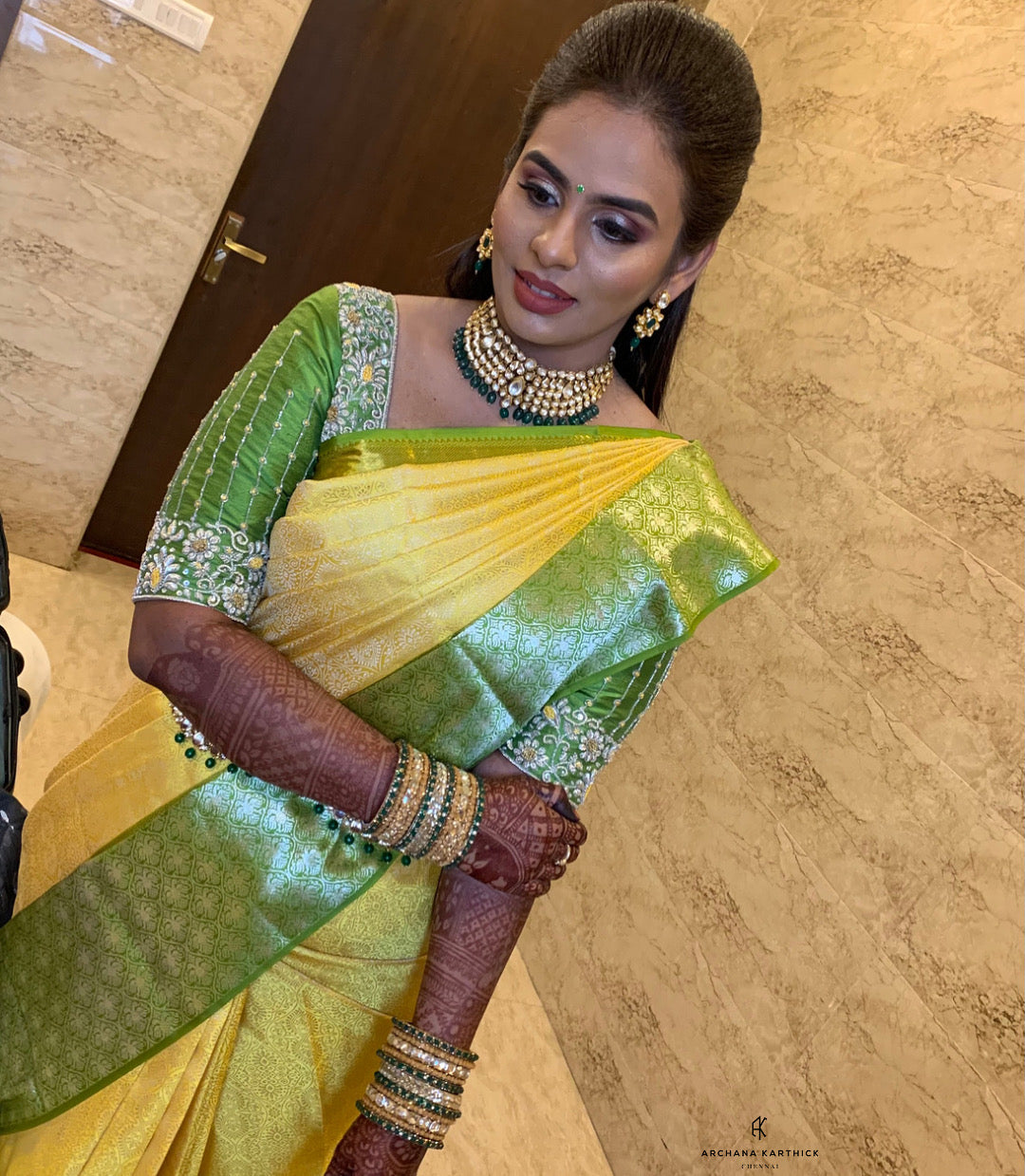 Bride Kowsalya in a handcrafted green silk blouse designed by Archana Karthick.