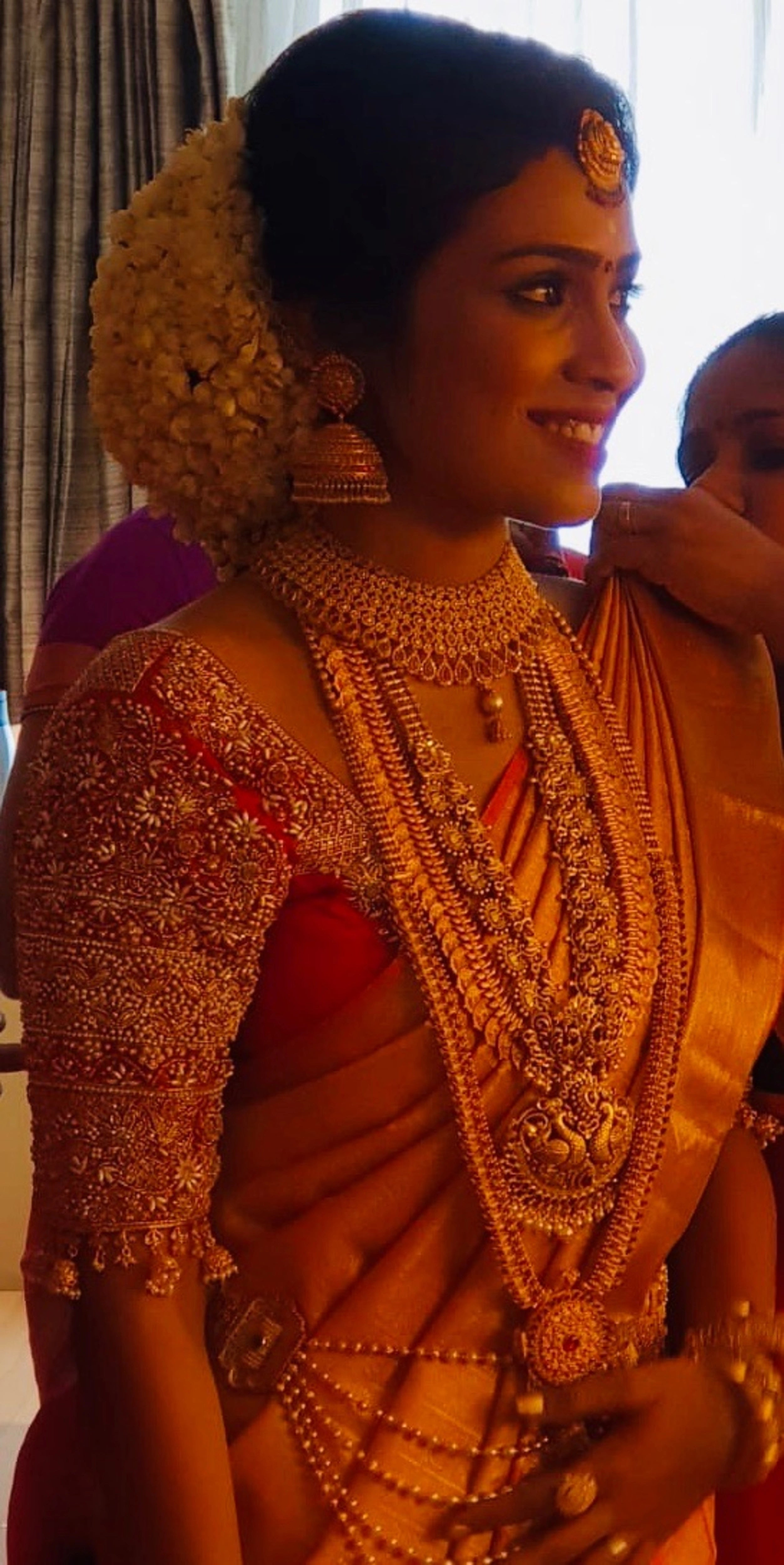 Bride Krishnapriya from Chennai posing in a pink silk blouse handcrafted intricately with beads, stones, pearls, cutdanas and zardozi by team Archana Karthick.