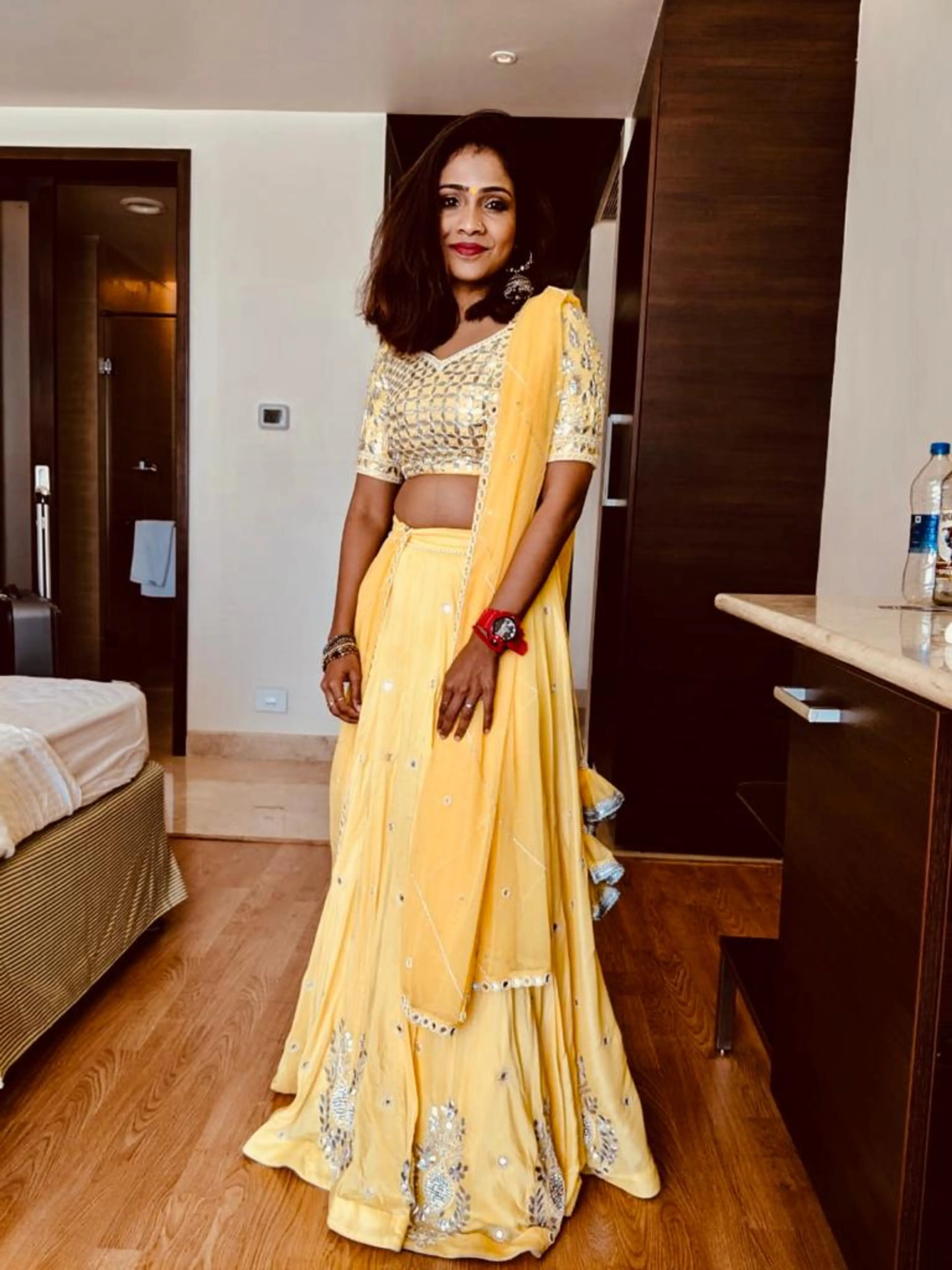 Bride Krishnapriya in a yellow lehenga designed by Archana Karthick.