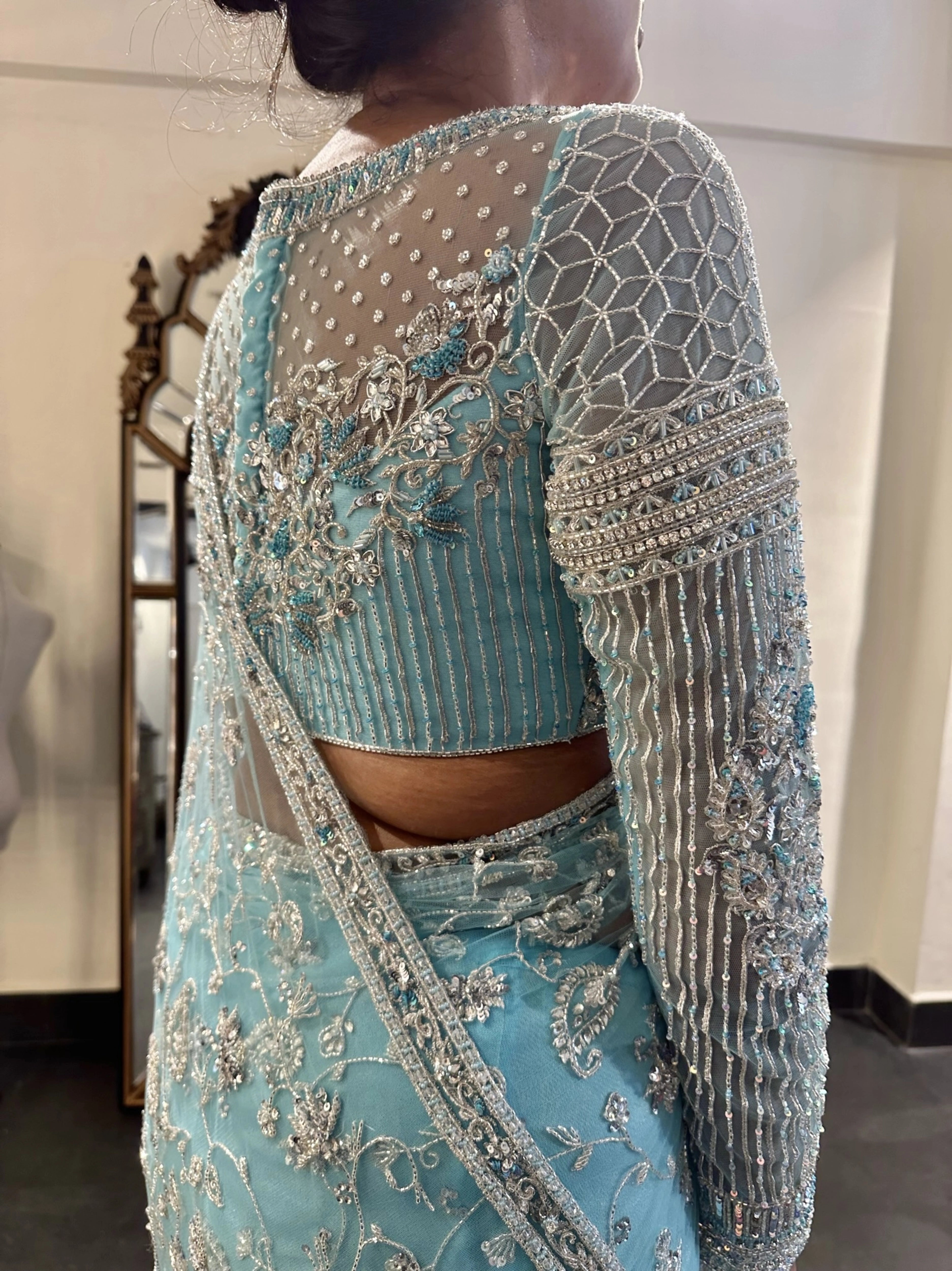 Bride Krithi from USA during fittings in a blue tulle saree, handcrafted by team Archana Karthick.