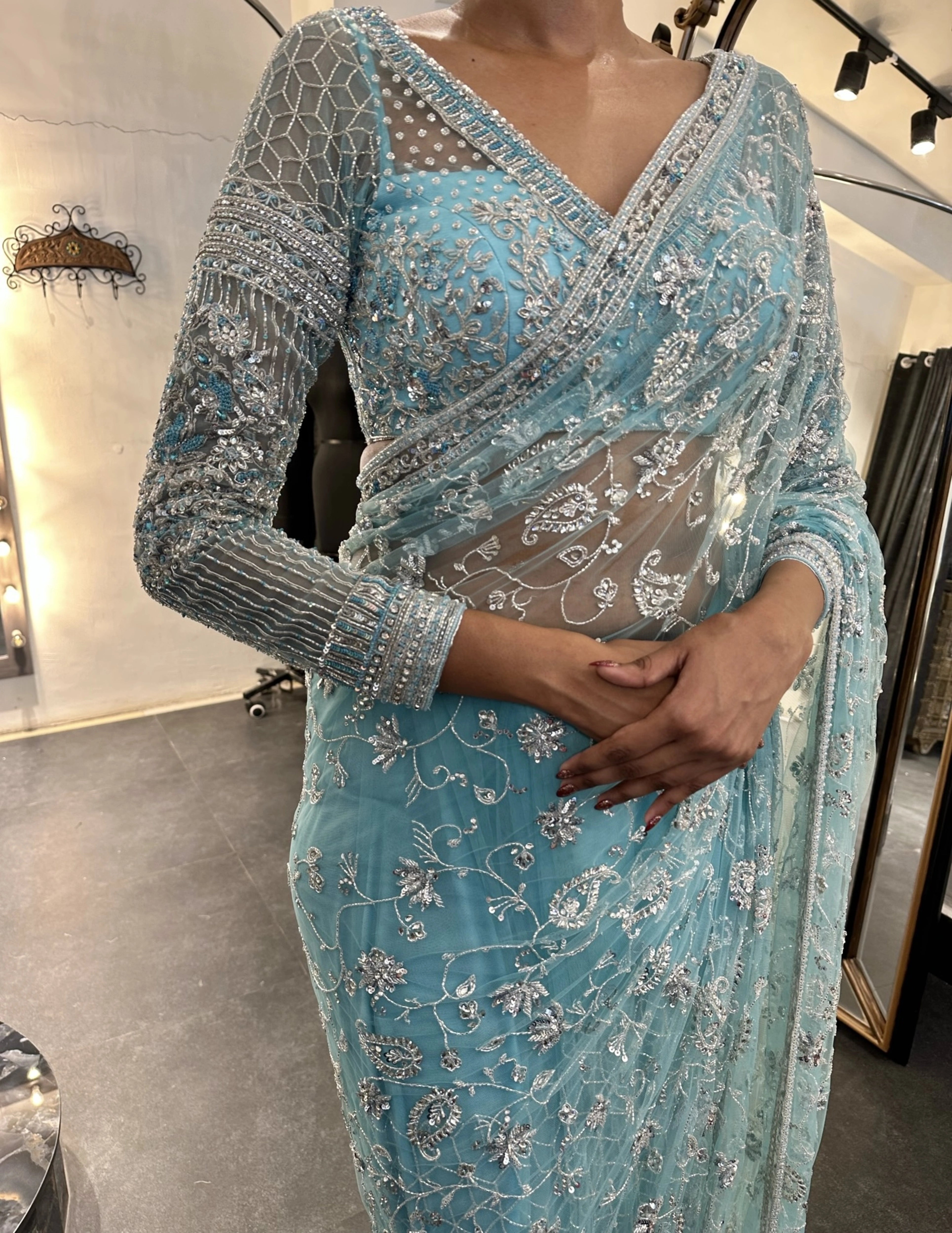 Bride Krithi from USA posing in a blue tulle saree, handcrafted by team Archana Karthick.