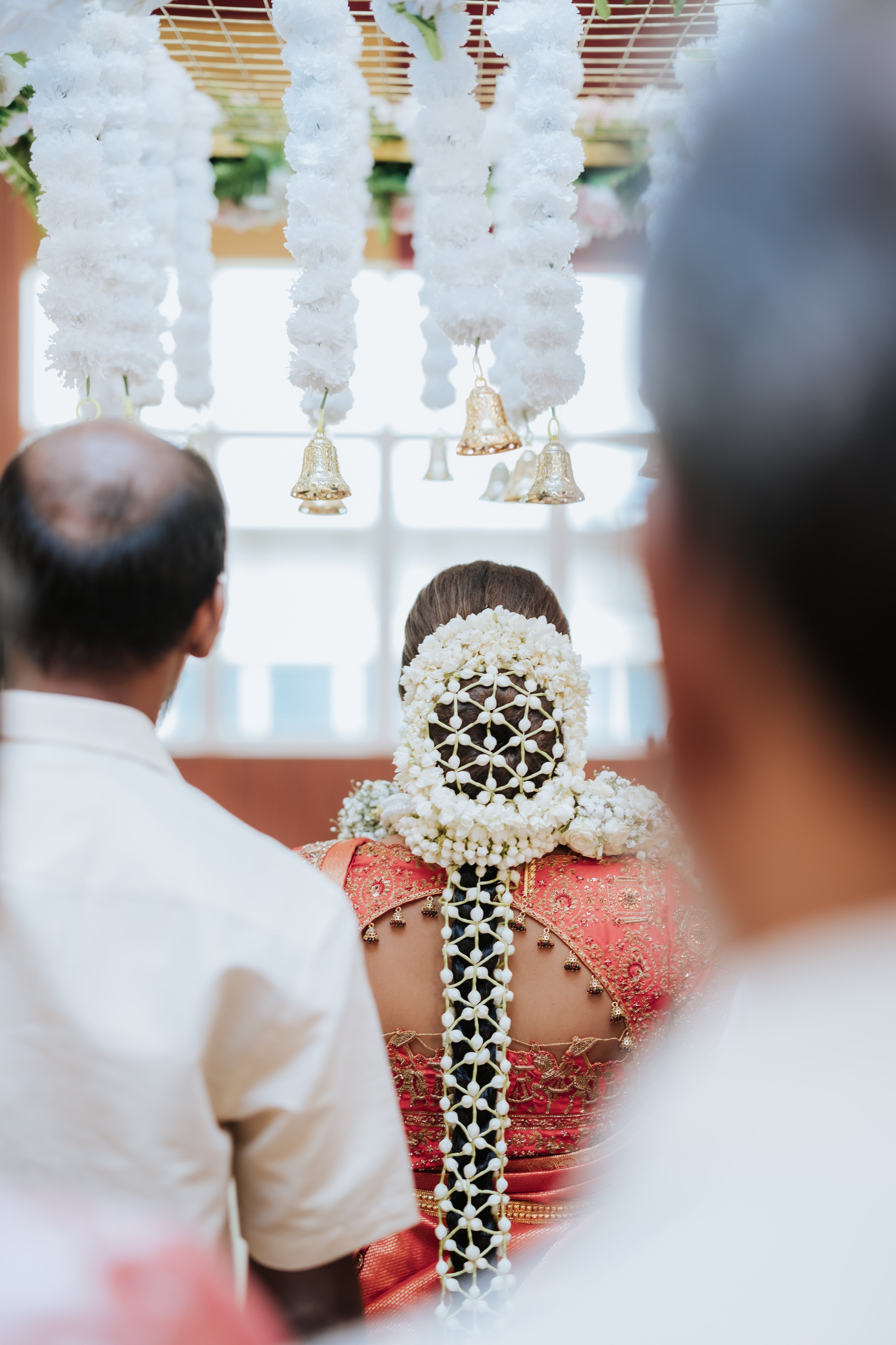 Bride Kritini Naidu from Malaysia during photoshoot in a red silk blouse & saree border by team Archana Karthick.