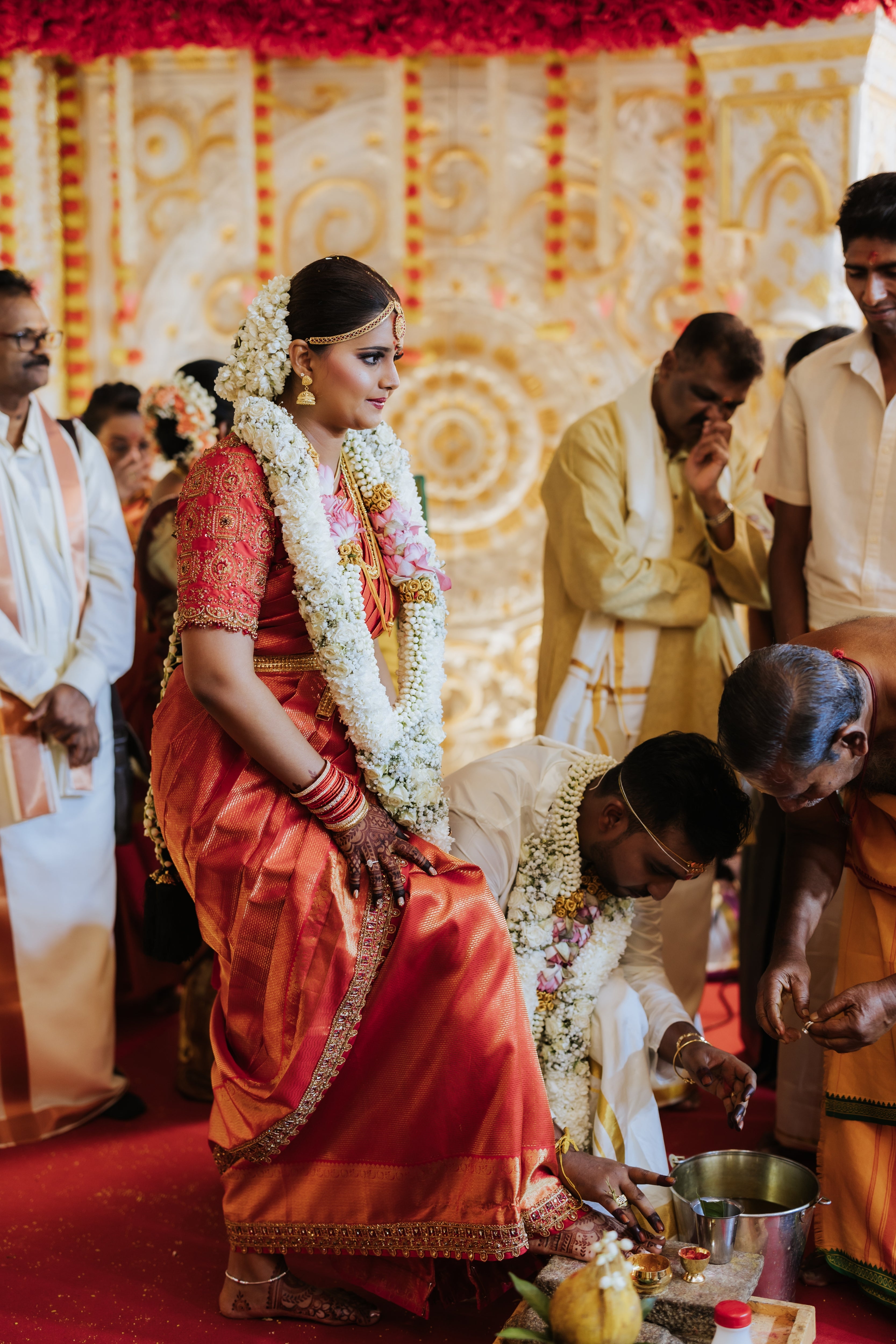 Bride Kritini Naidu from Malaysia during rituals in a red silk blouse & saree border by team Archana Karthick.