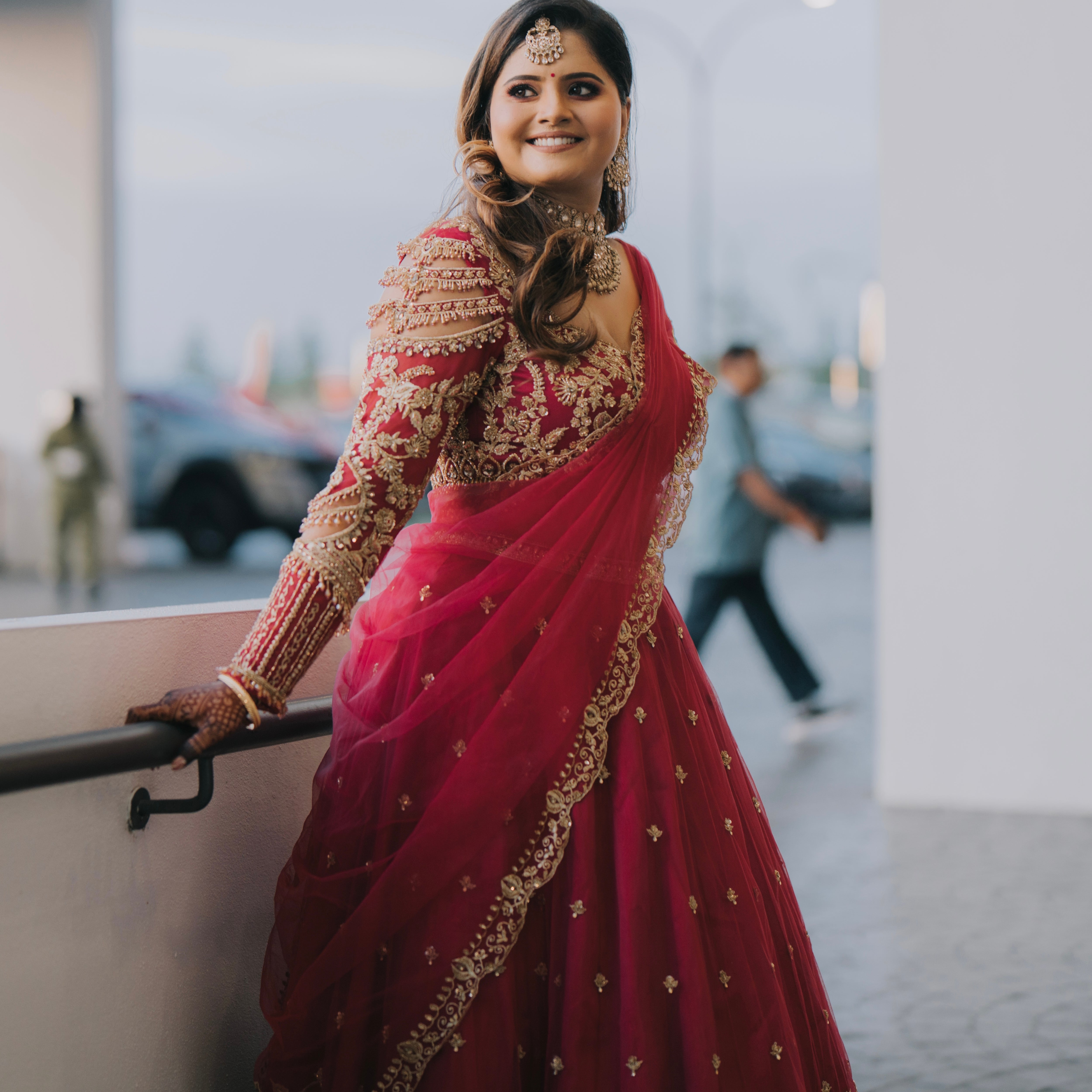 Bride Kritini Naidu from Malaysia posing for photo in a pink lehenga by Archana