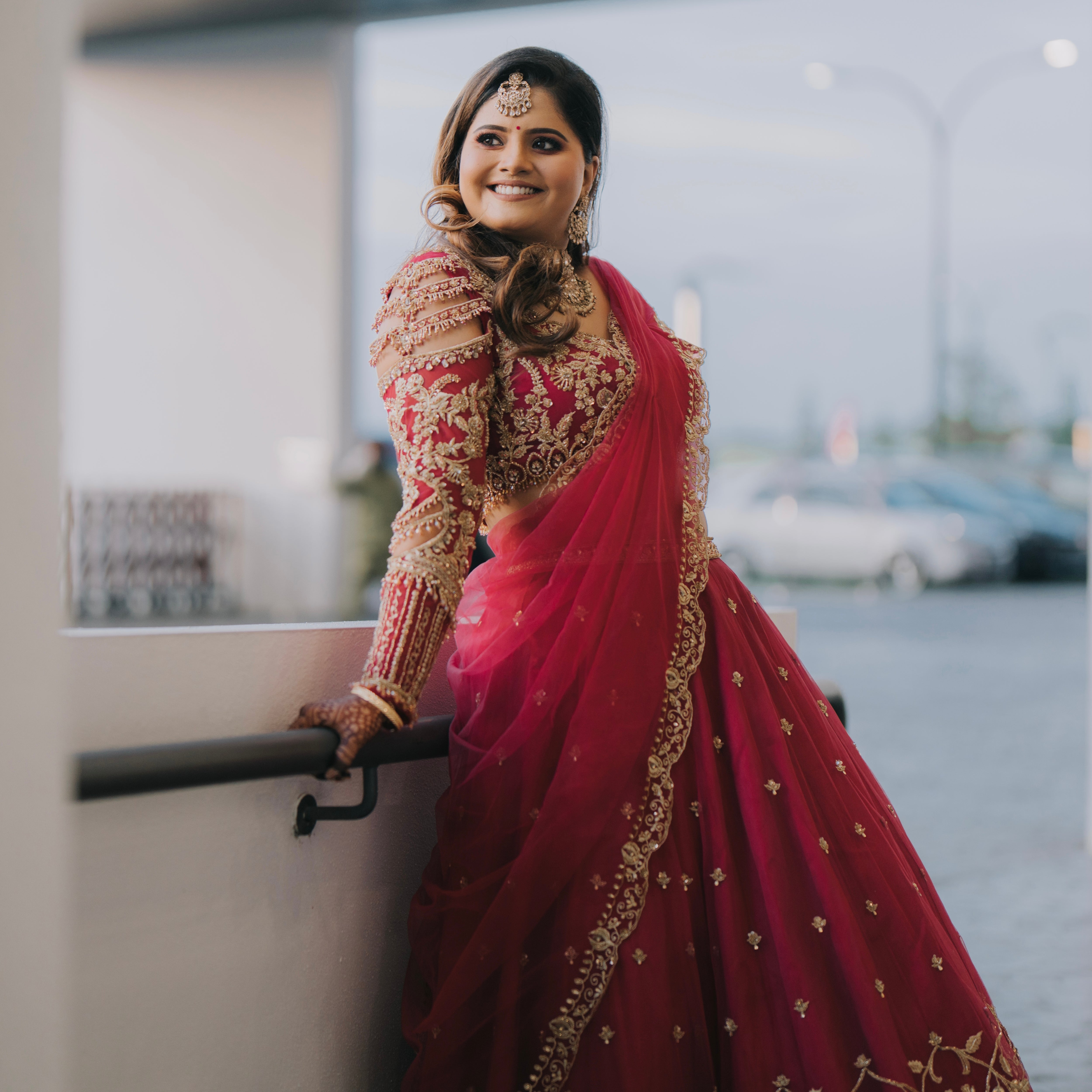 Bride Kritini Naidu from Malaysia smiling for photo in a pink lehenga by Archana