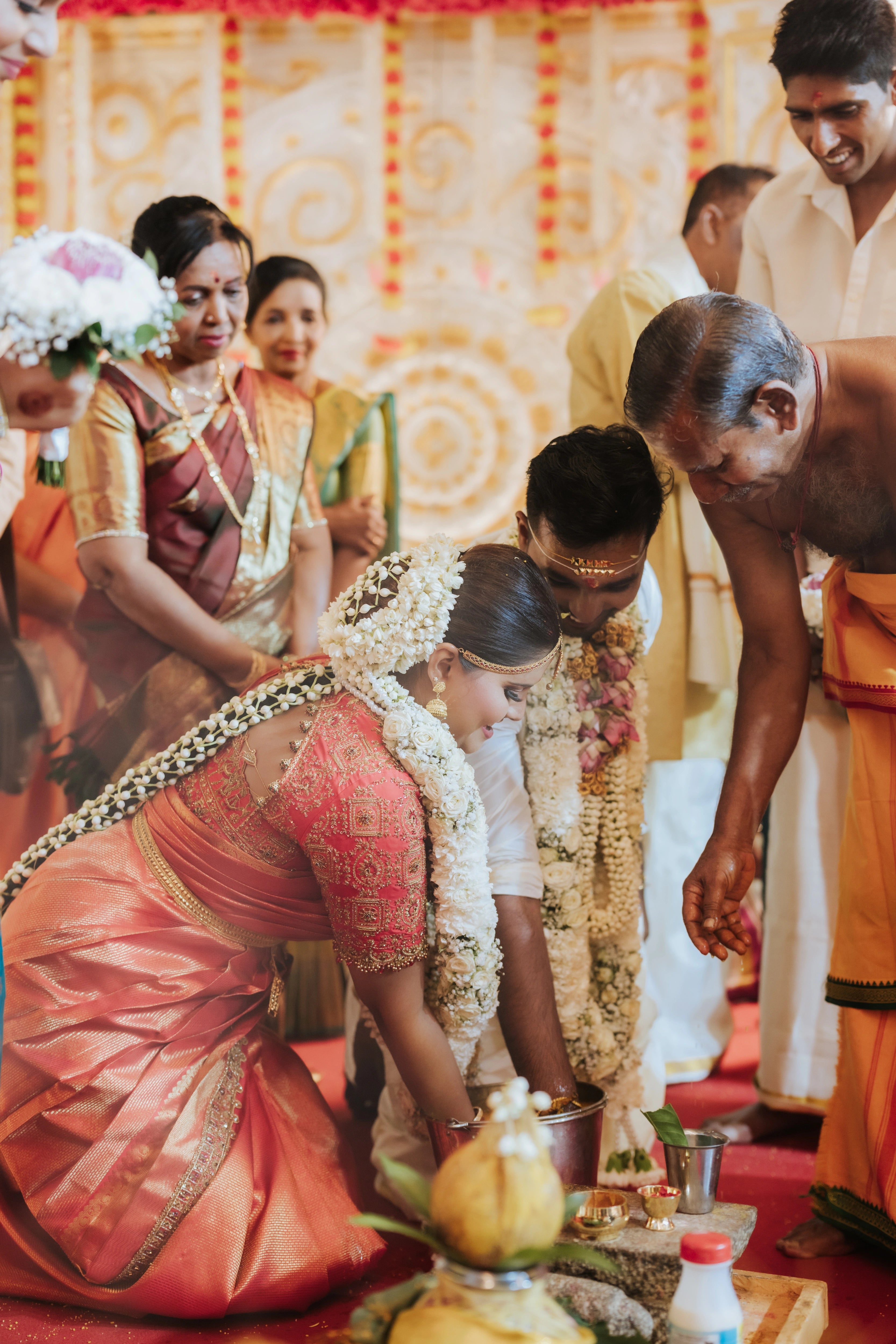 Bride Kritini Naidu from Malaysia with groom in a red silk blouse & saree border by team Archana Karthick.