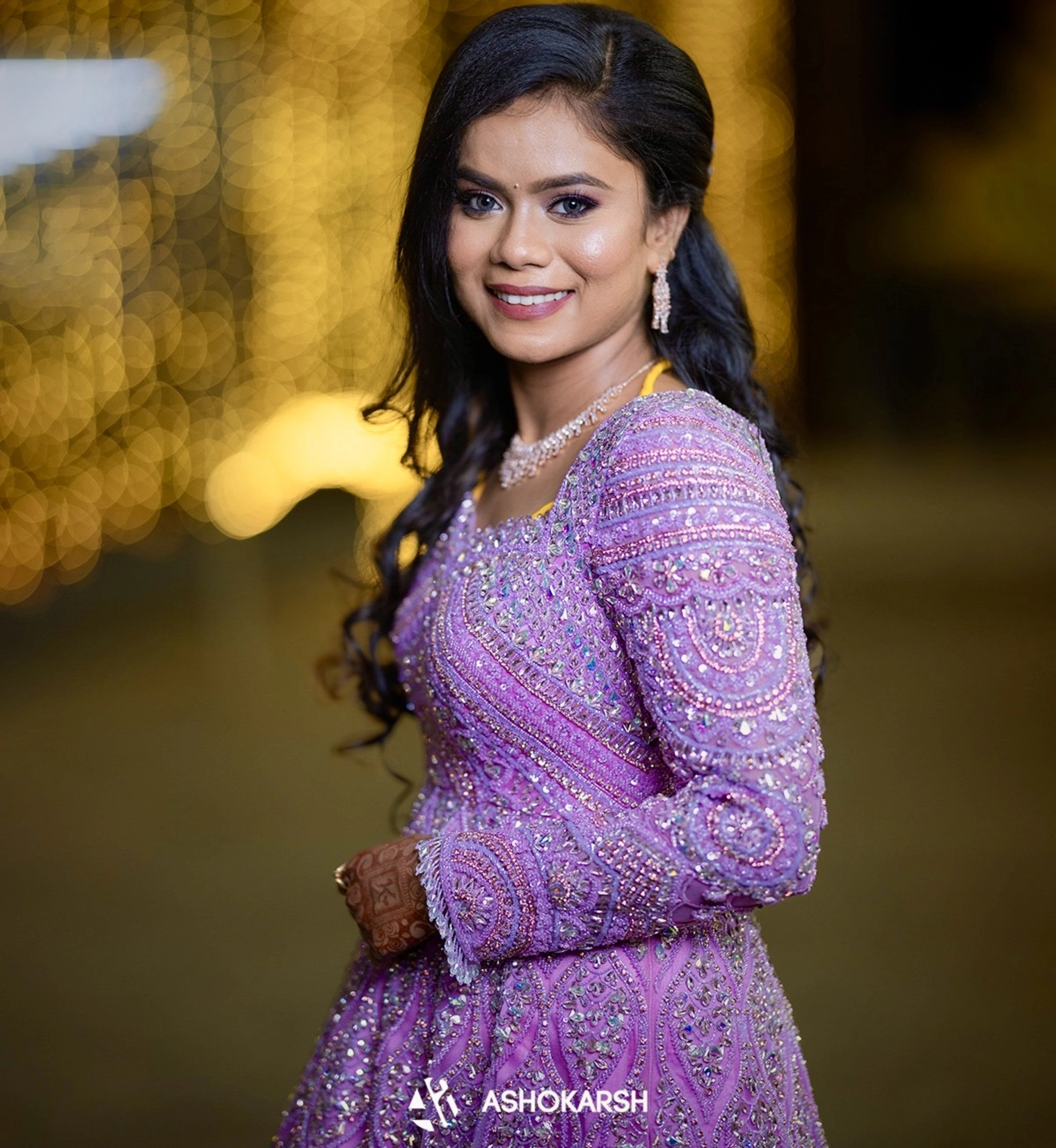 Bride Kushmma smiling in a lilac pink ombre gown by team Archana Karthick