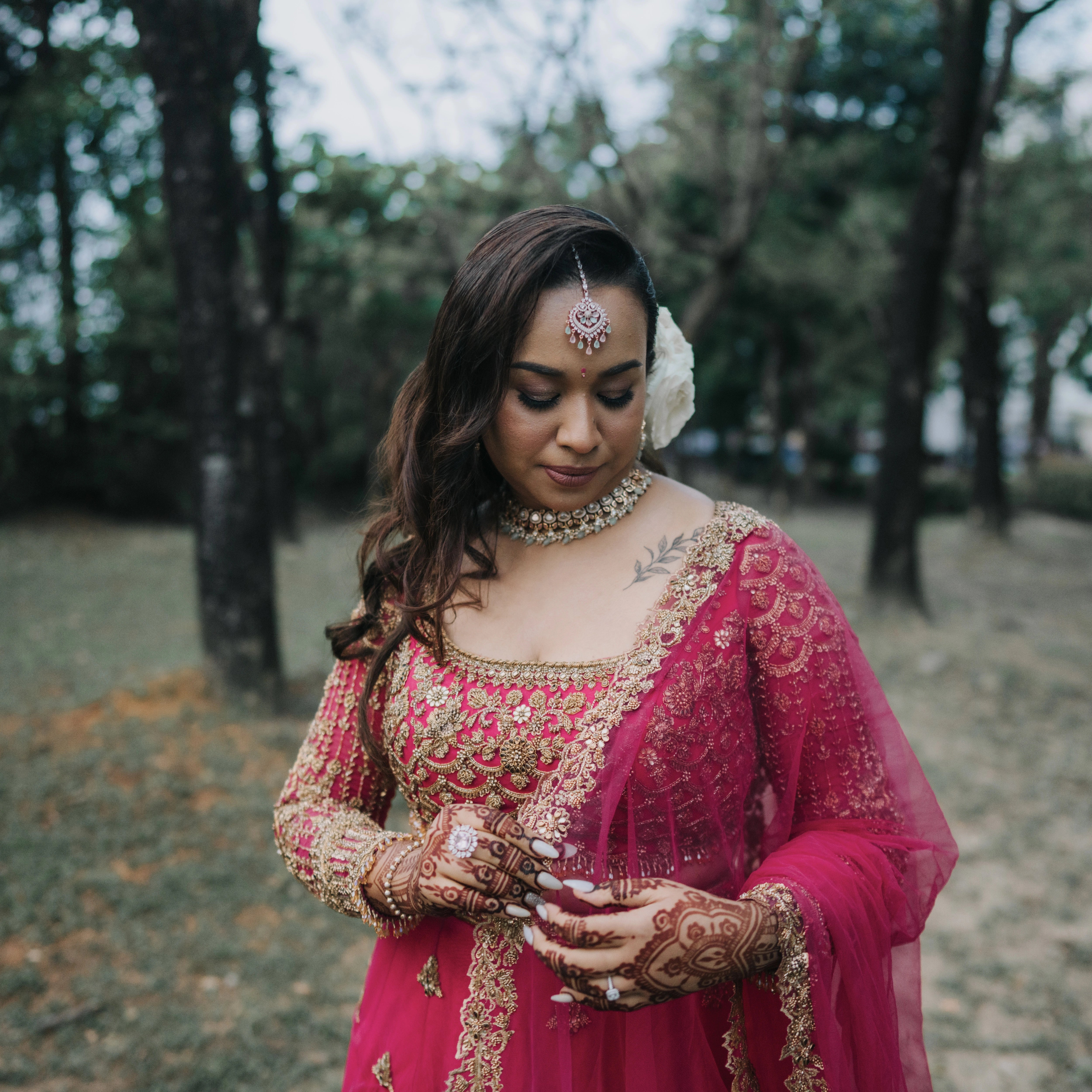Bride Lalina from Malaysia posing in a pink & purple ombre lehnega, intricately handcrafted with zardozi, beads, sequions, knot work and crystals.