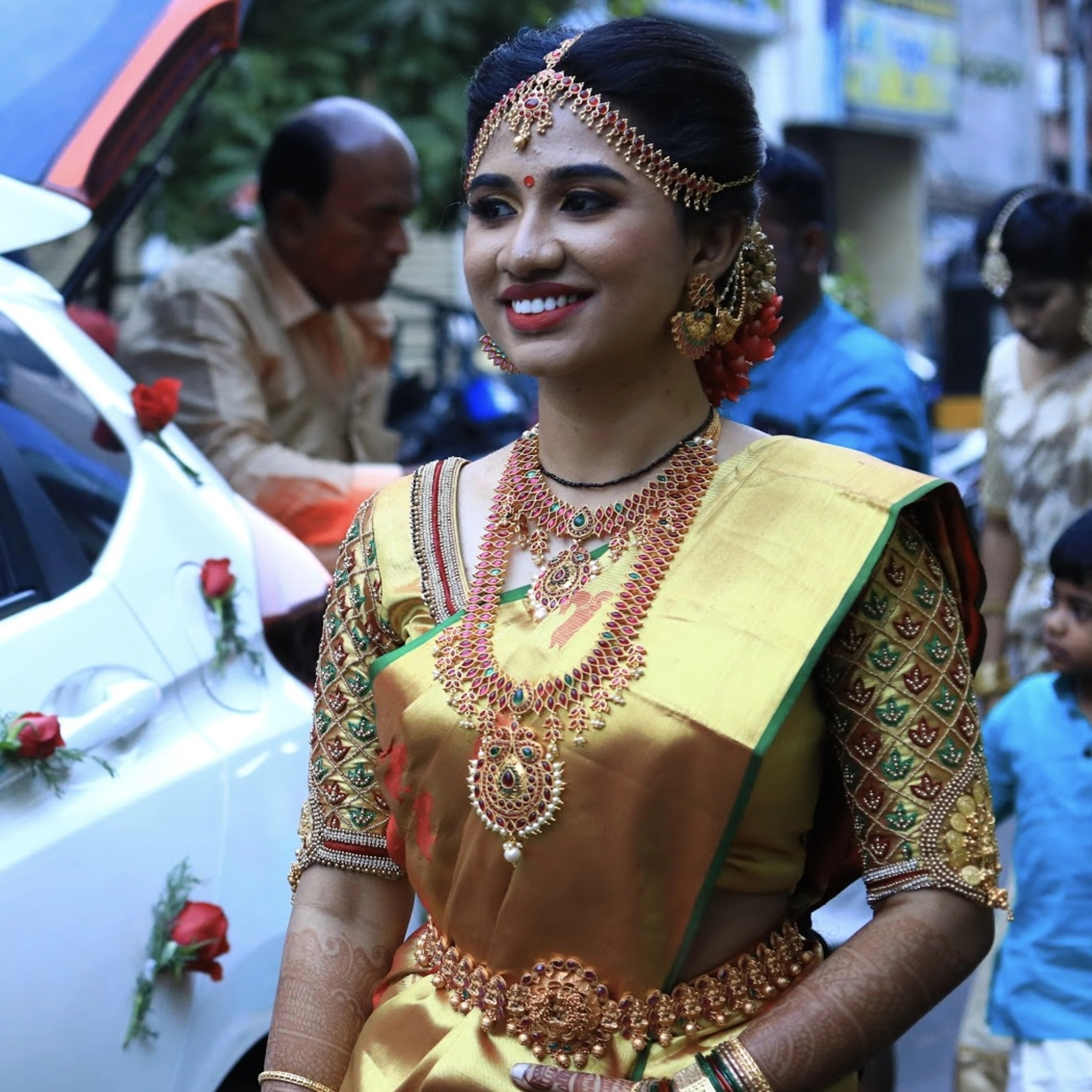 Bride Mahalakshmi in a gold silk blouse handcrafted by team Archana Karthick.