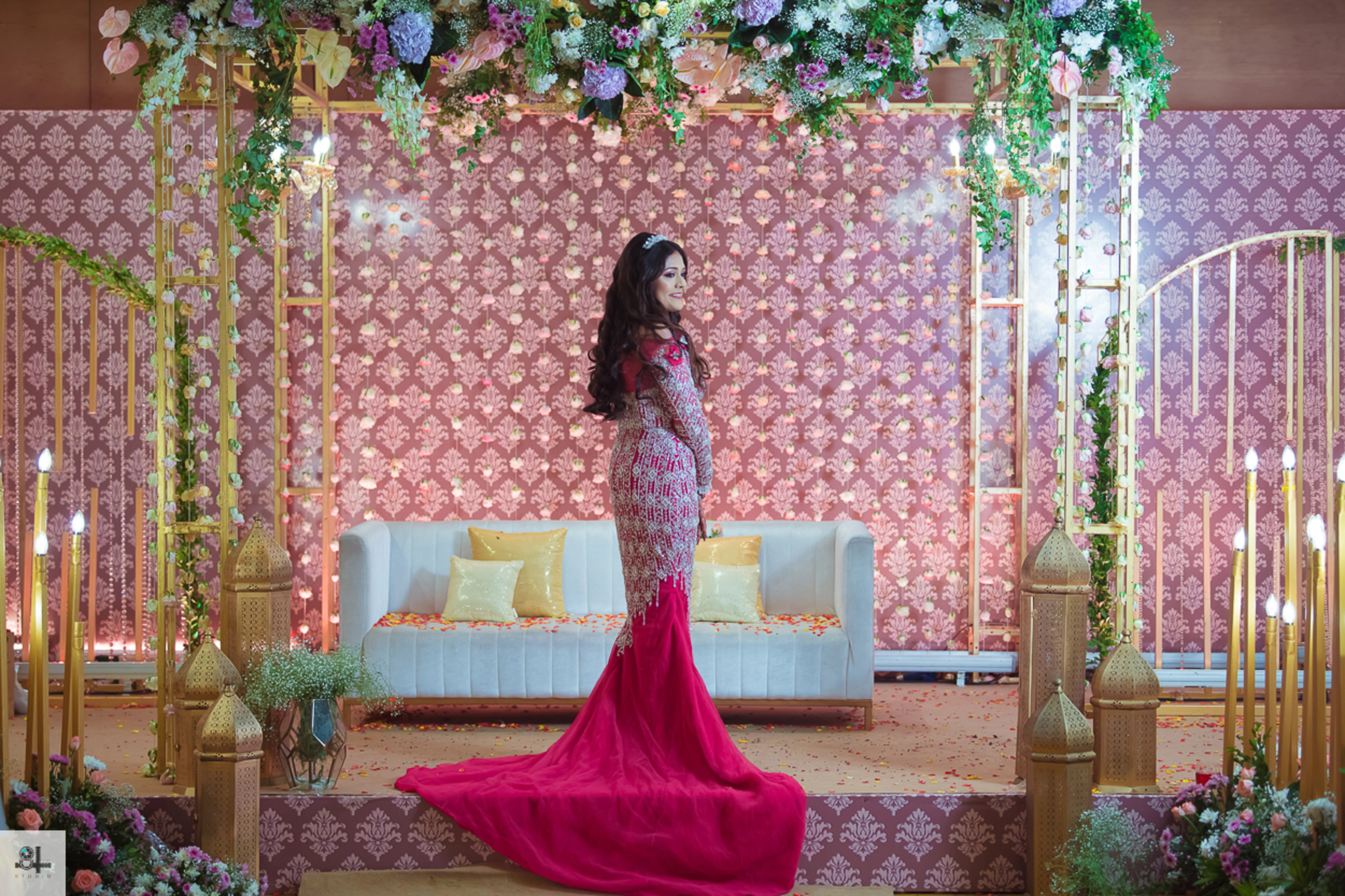 Bride Maygha Viswanath from UK in a hot pink mermaid gown by team Archana Karthick.