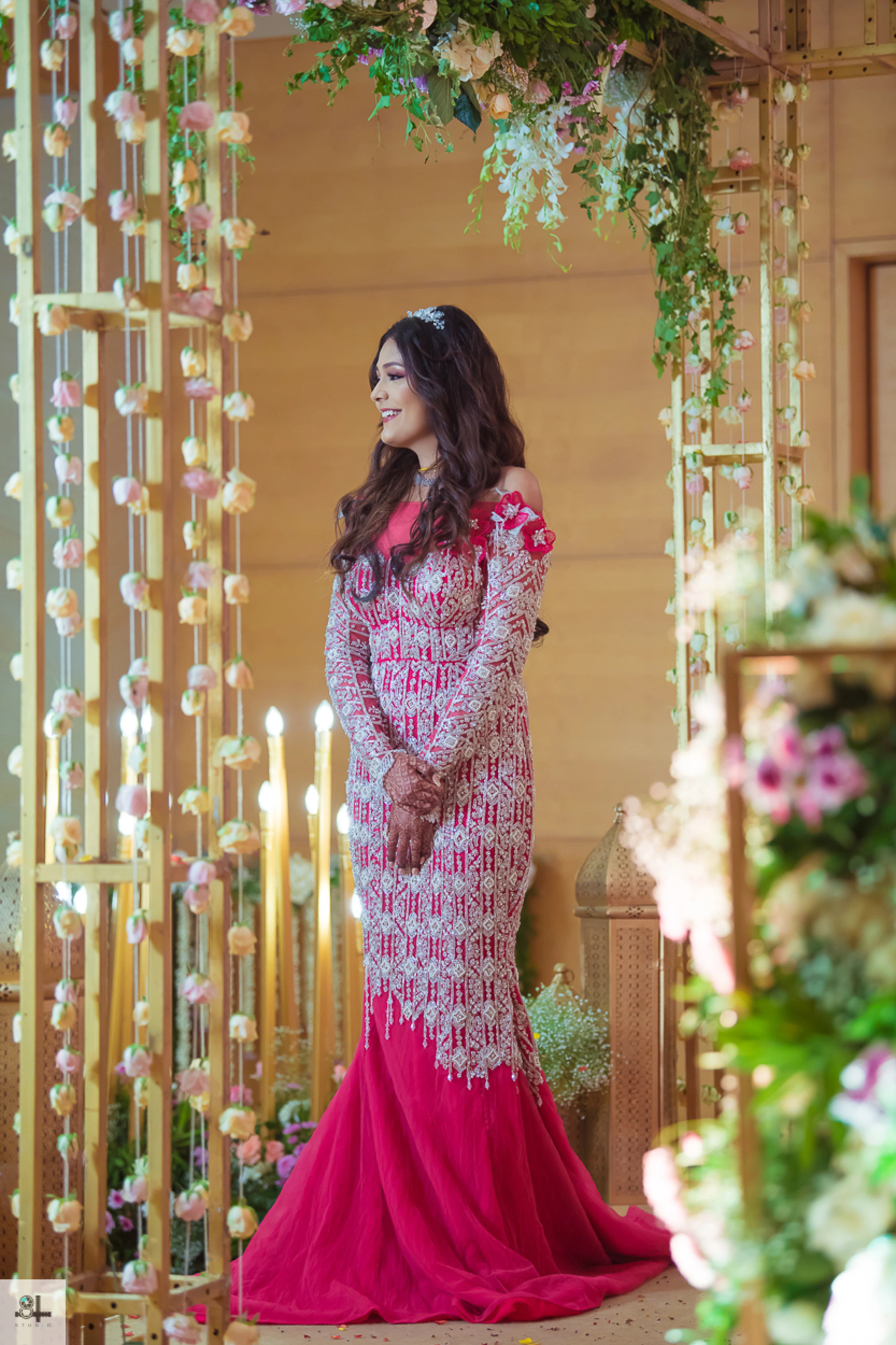 Bride Maygha Viswanath from UK posing in a hot pink mermaid gown by team Archana Karthick.