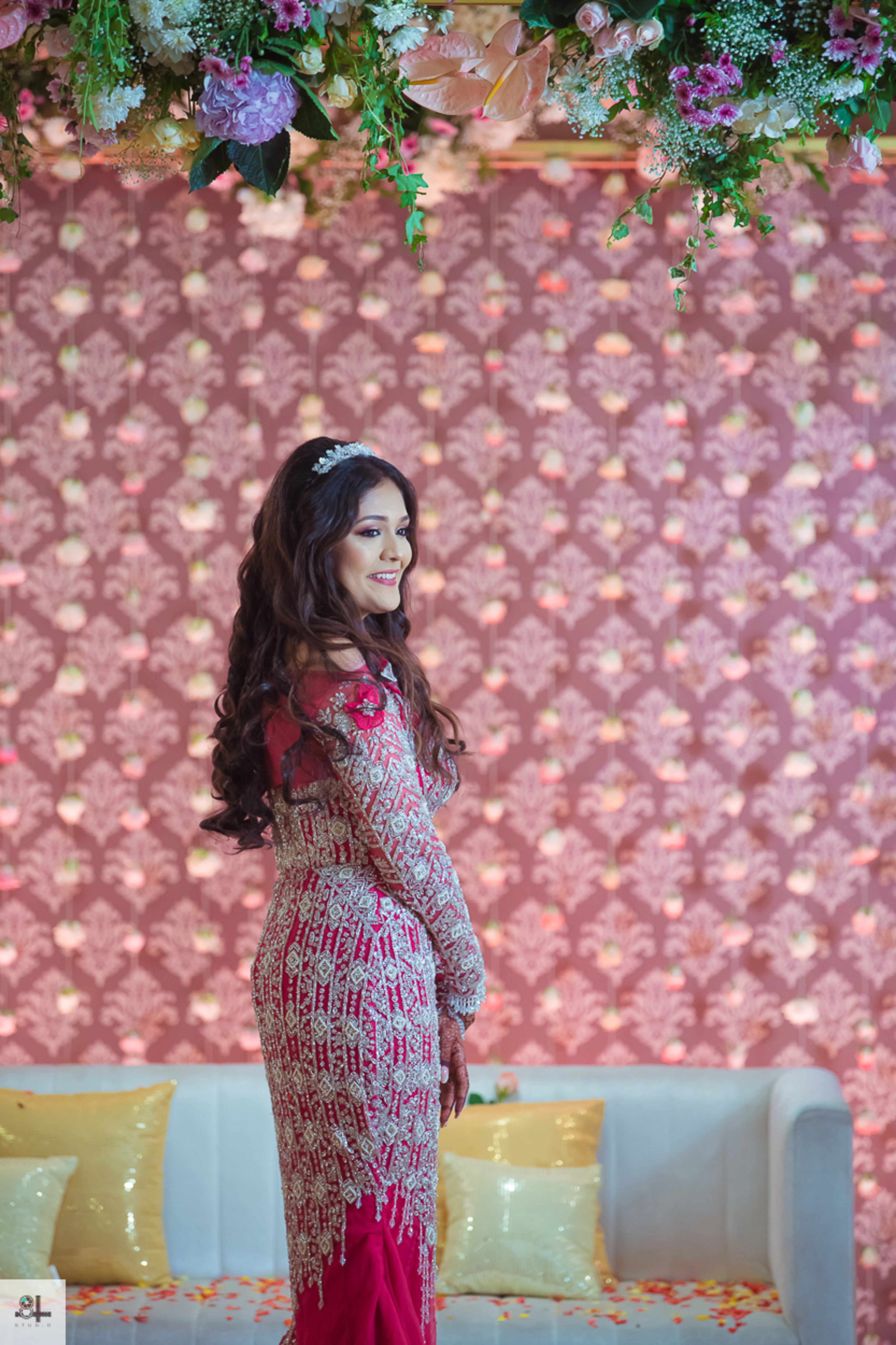 Bride Maygha Viswanath from UK posing on stage in a hot pink mermaid gown by team Archana Karthick.
