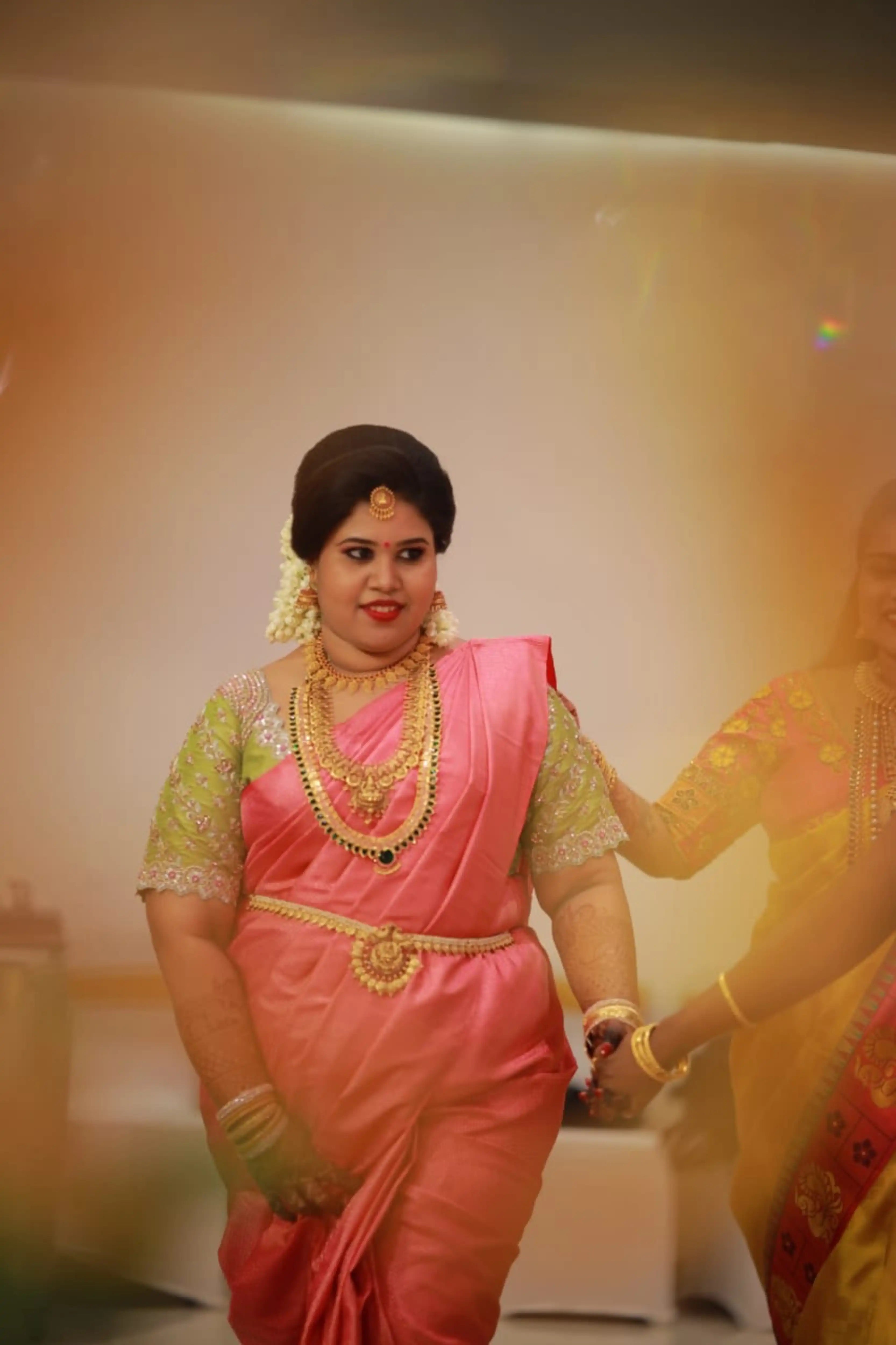 Bride Monisha from Kerala in a lime green silk blouse handcrafted by team Archana Karthick.