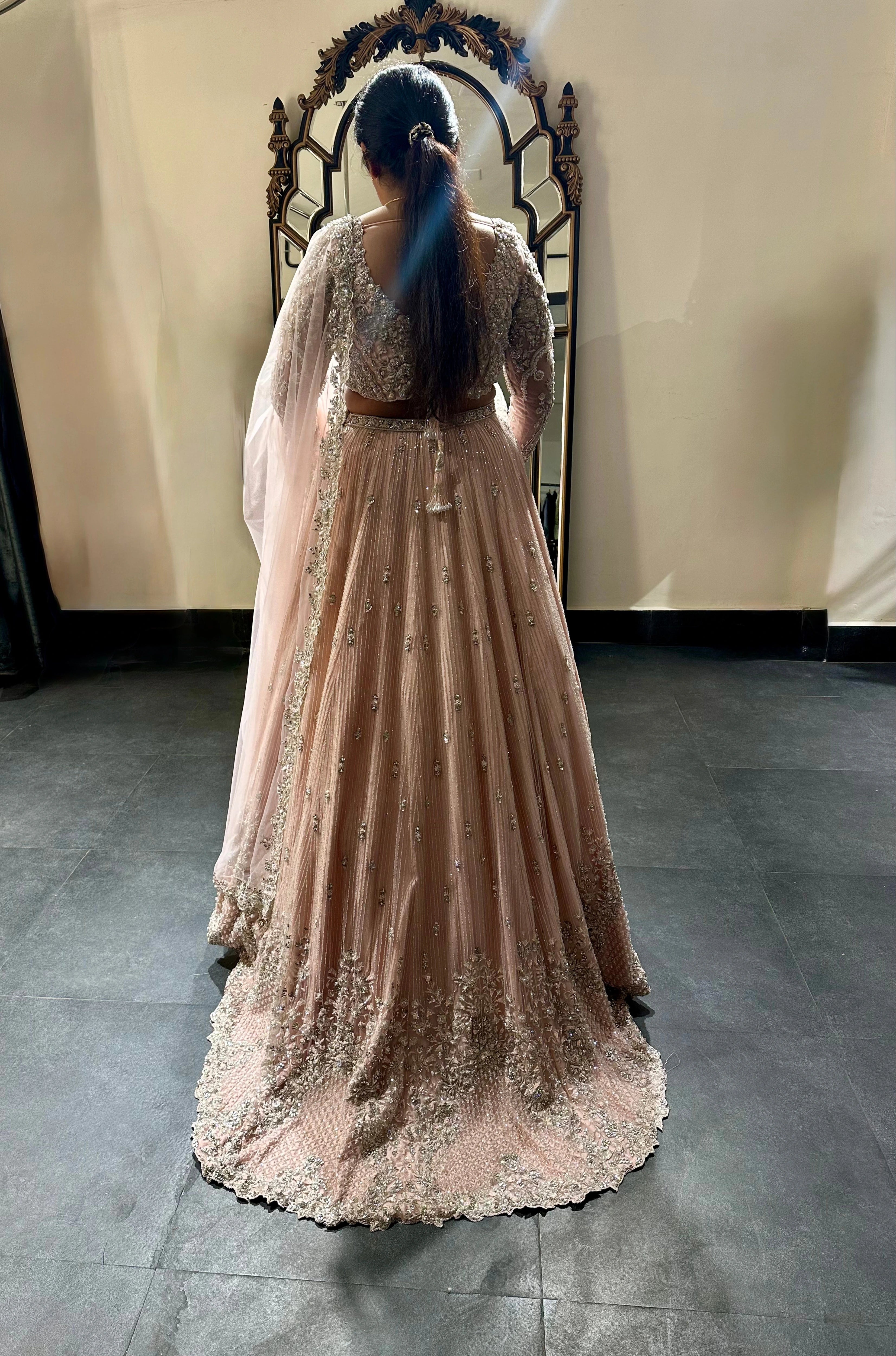 Bride Nandhini Krishnan during fittings in a blush tulle reception lehenga, handcrafted by team Archana Karthick.