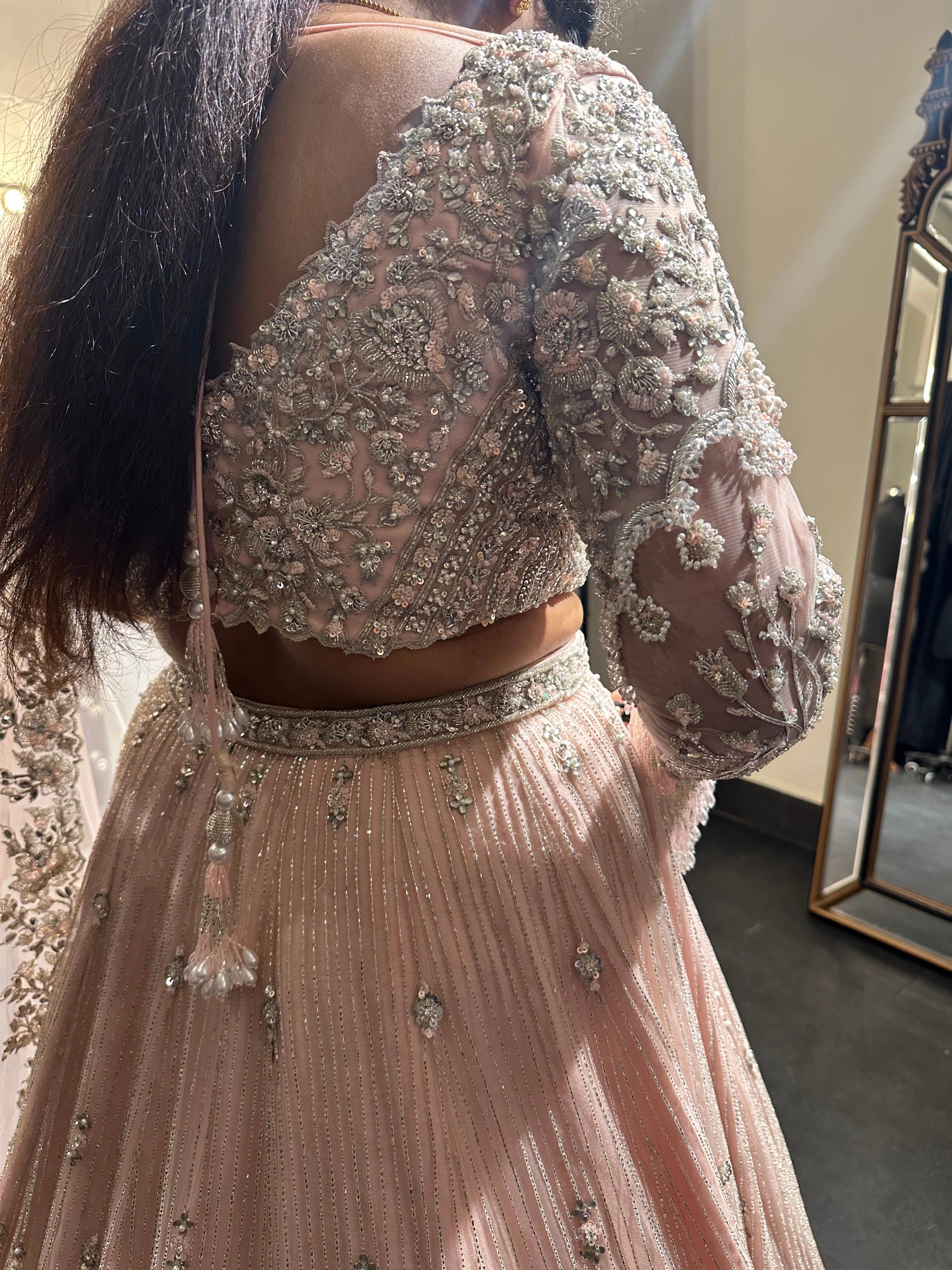 Bride Nandhini Krishnan during her fittings in a blush tulle reception lehenga, handcrafted by team Archana Karthick.