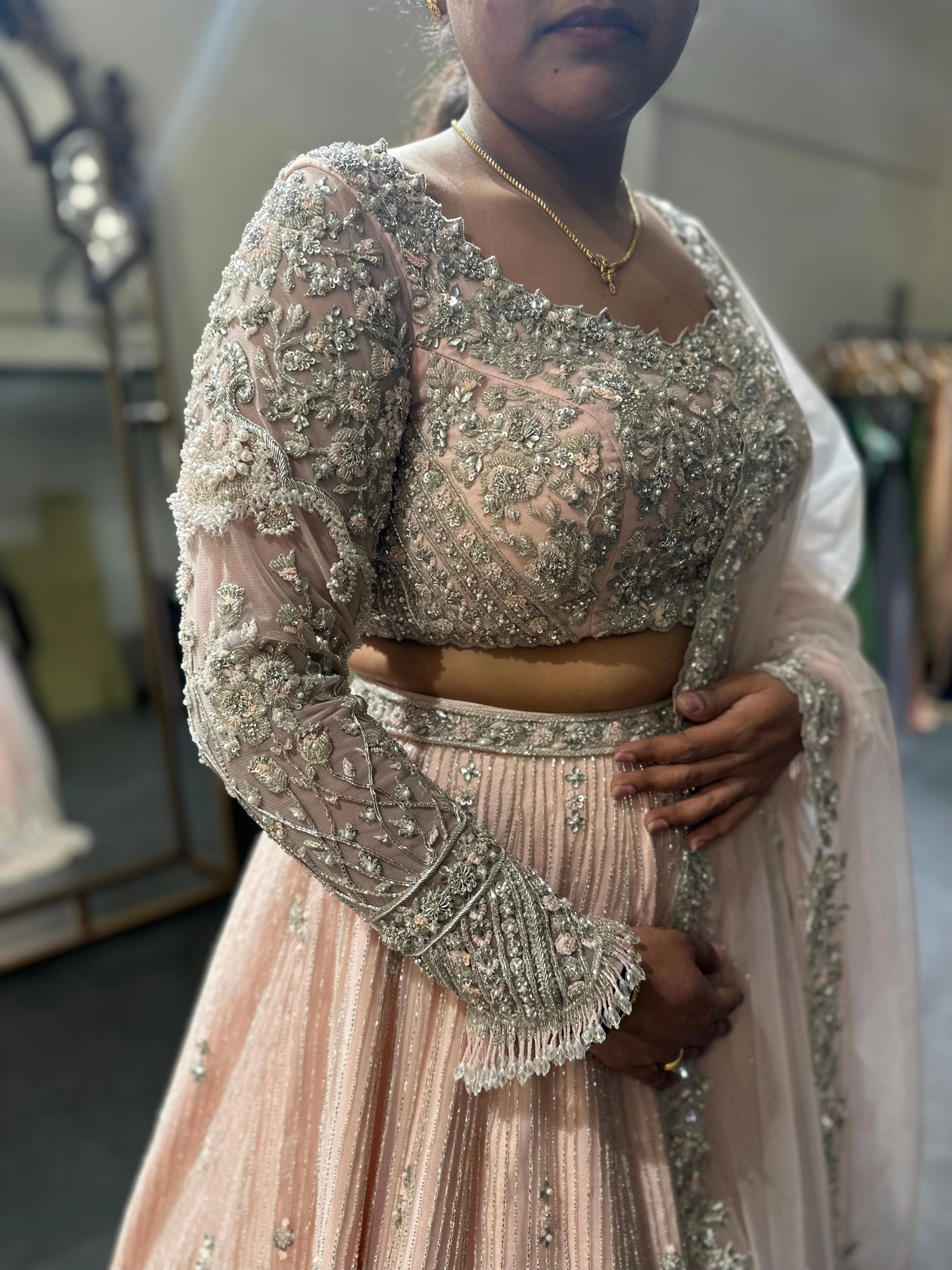 Bride Nandhini Krishnan during the fittings in a blush tulle reception lehenga, handcrafted by team Archana Karthick.