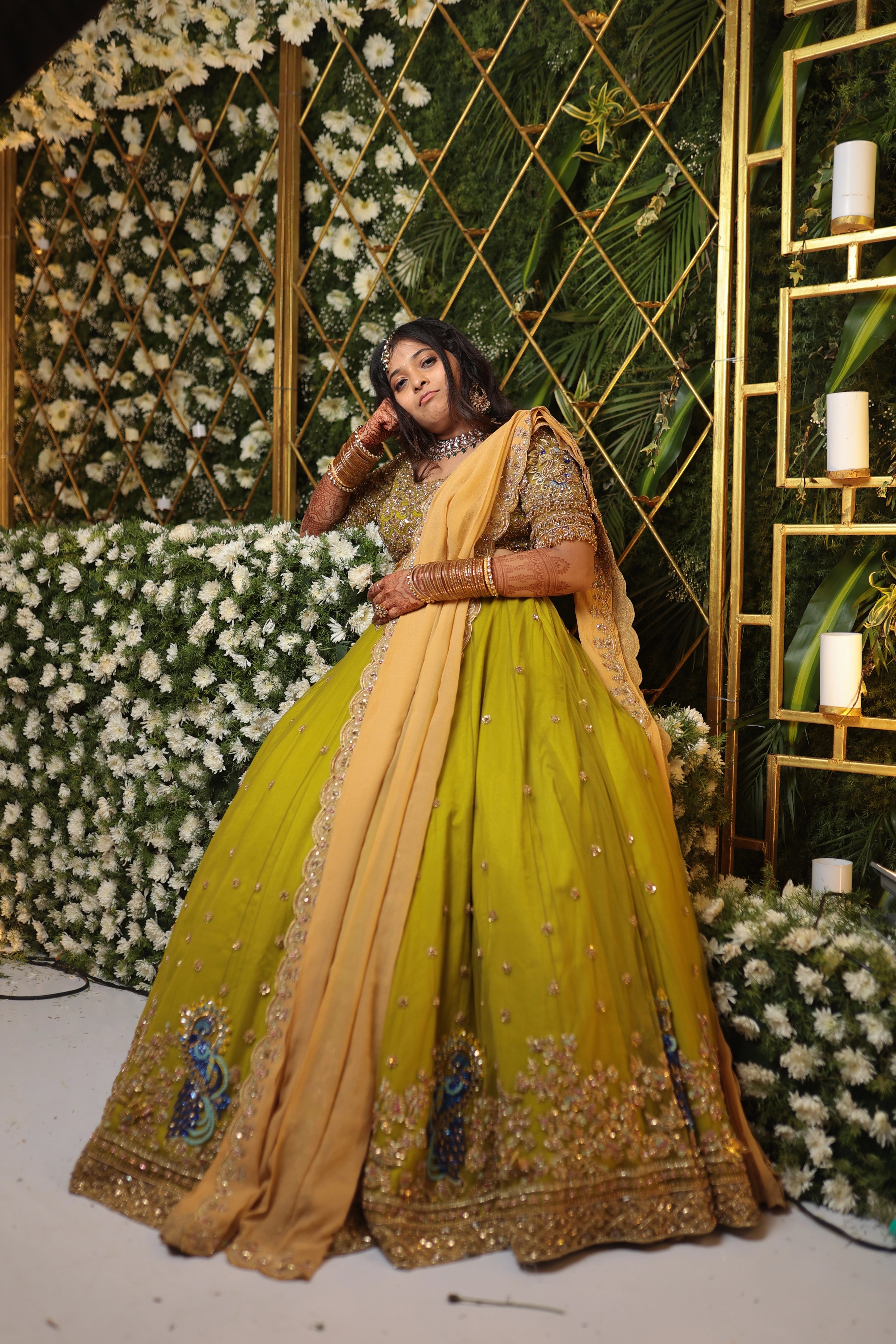 Bride Nandita posing for photo in a olive green tulle lehenga by team Archana Karthick.