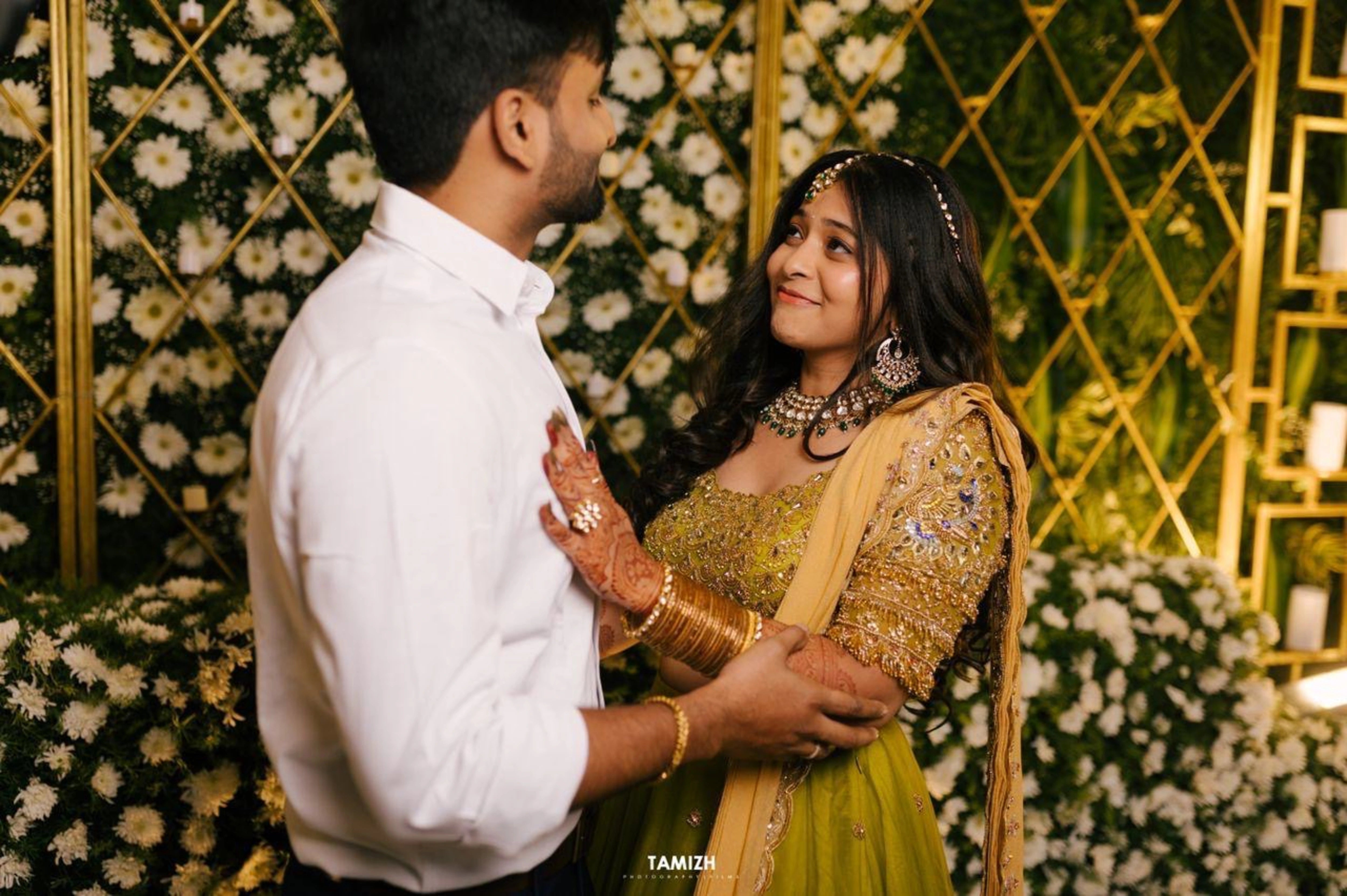 Bride Nandita posing in a olive green tulle lehenga by team Archana Karthick.