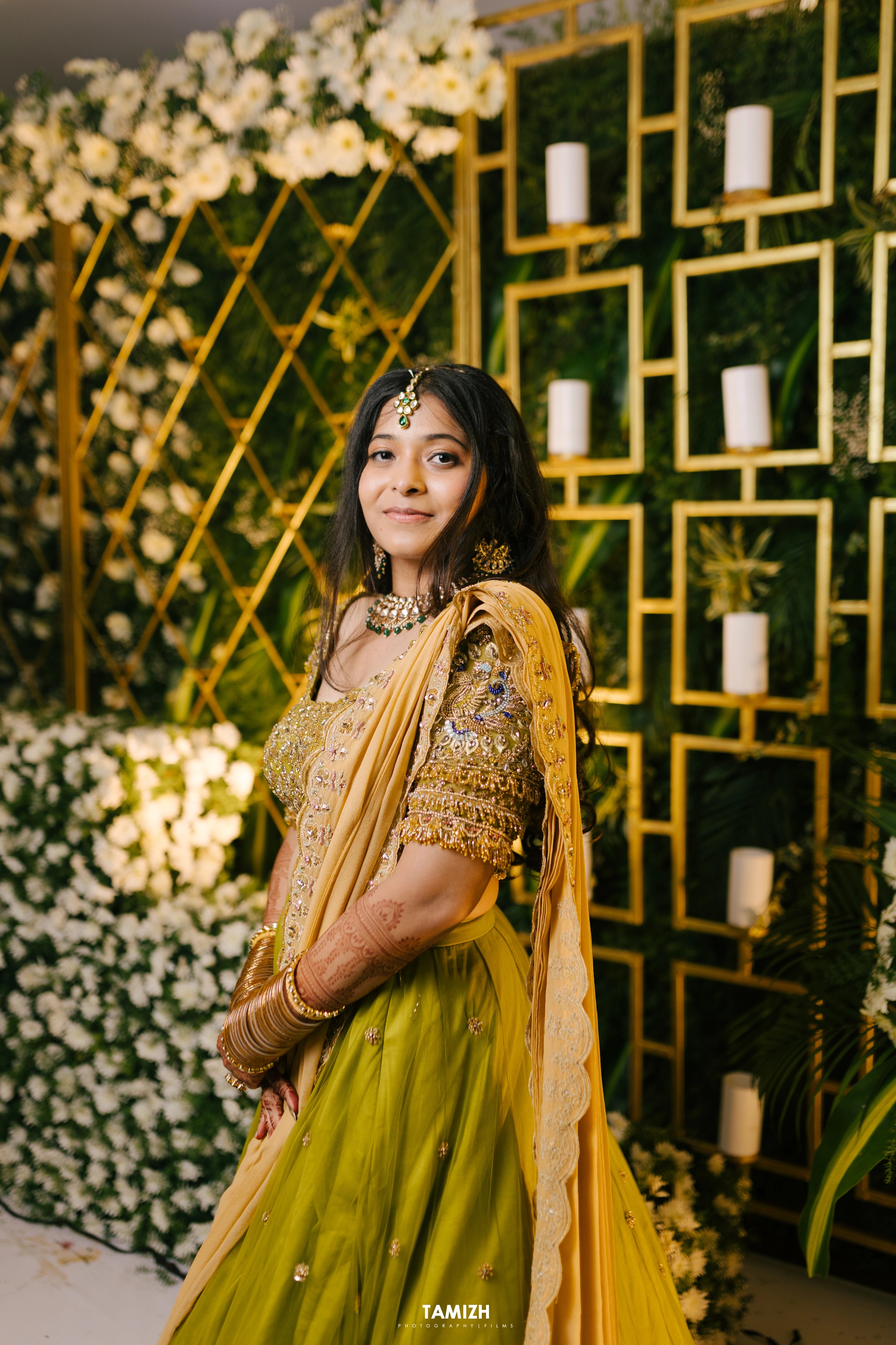 Bride Nandita smiling in a olive green tulle lehenga by team Archana Karthick.