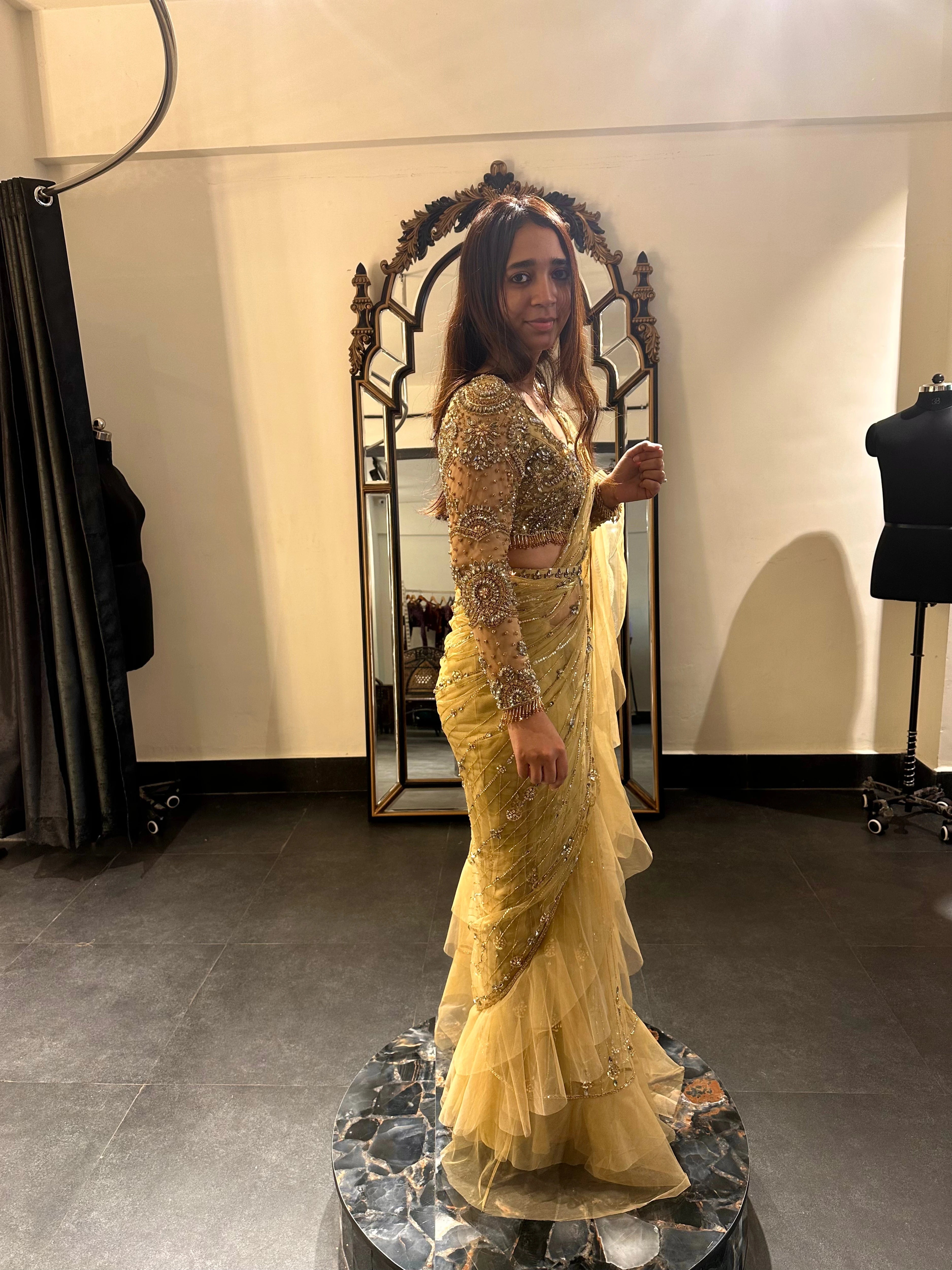 Bride Narmada during her fittings in a golden beige tulle saree handcrafted by team Archana Karthick.