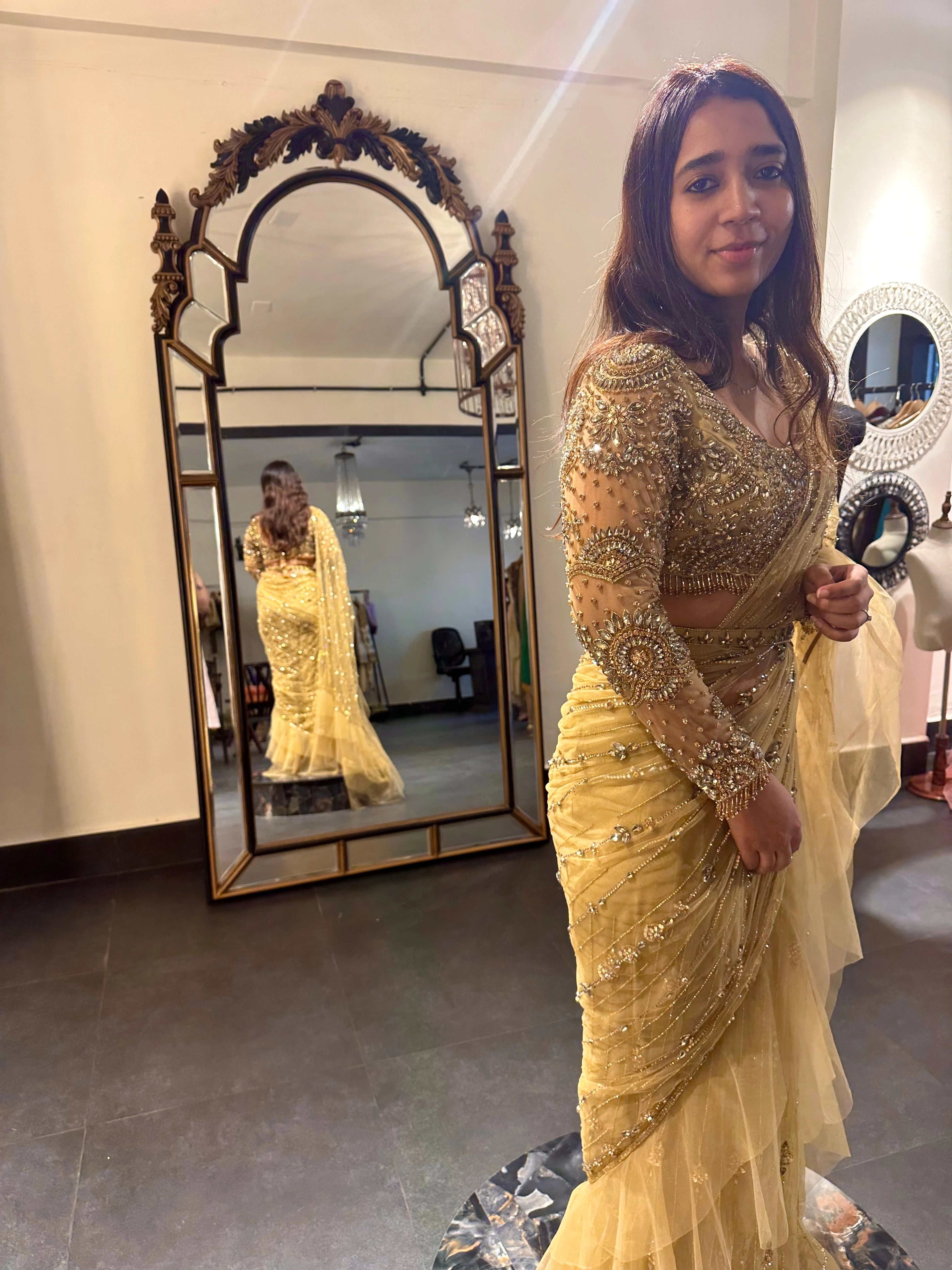 Bride Narmada poses during her fittings in a golden beige tulle saree handcrafted by team Archana Karthick.