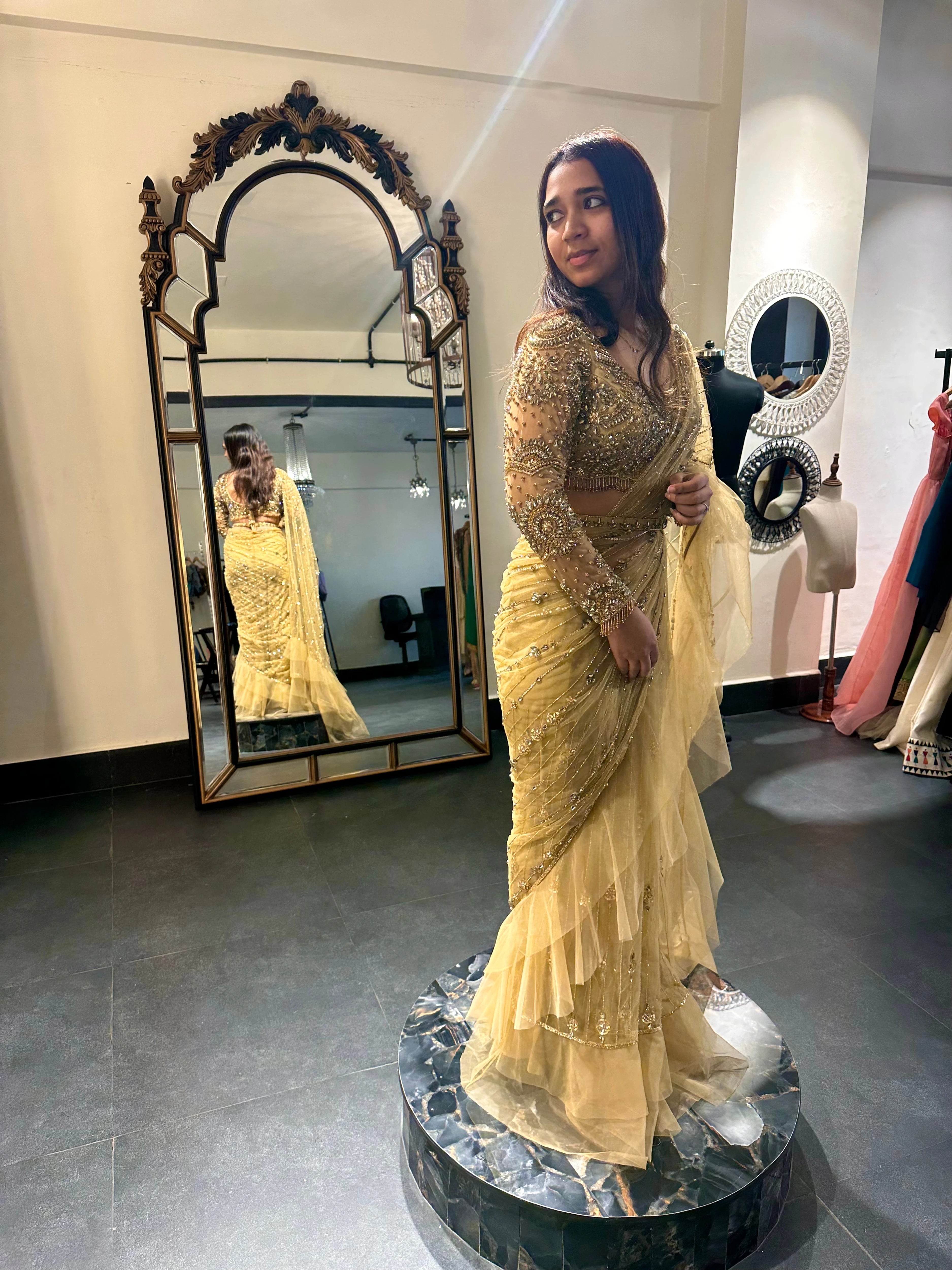 Bride Narmada posing during her fittings in a golden beige tulle saree handcrafted by team Archana Karthick.