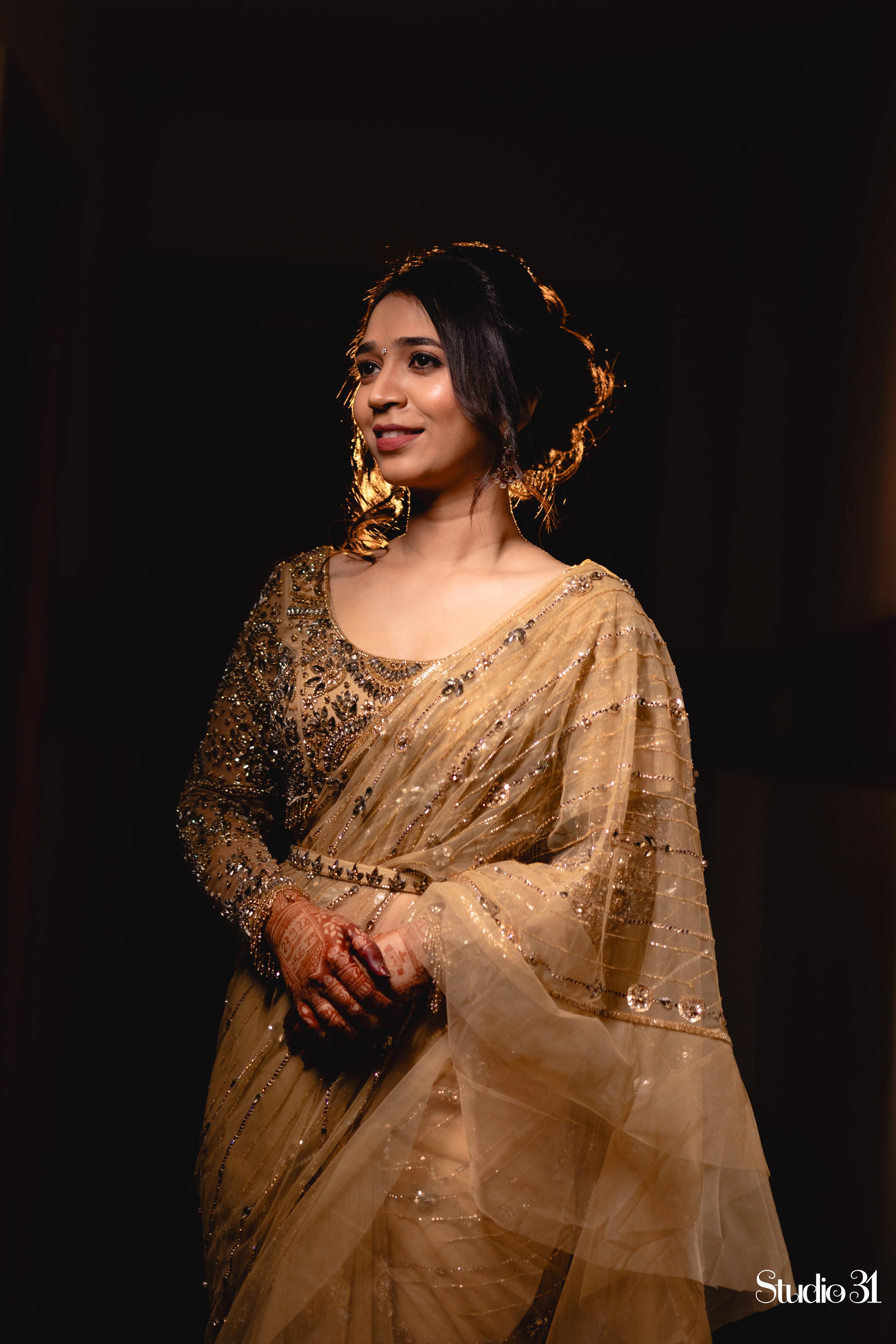 Bride Narmada posing in a golden beige tulle saree handcrafted by team Archana Karthick.