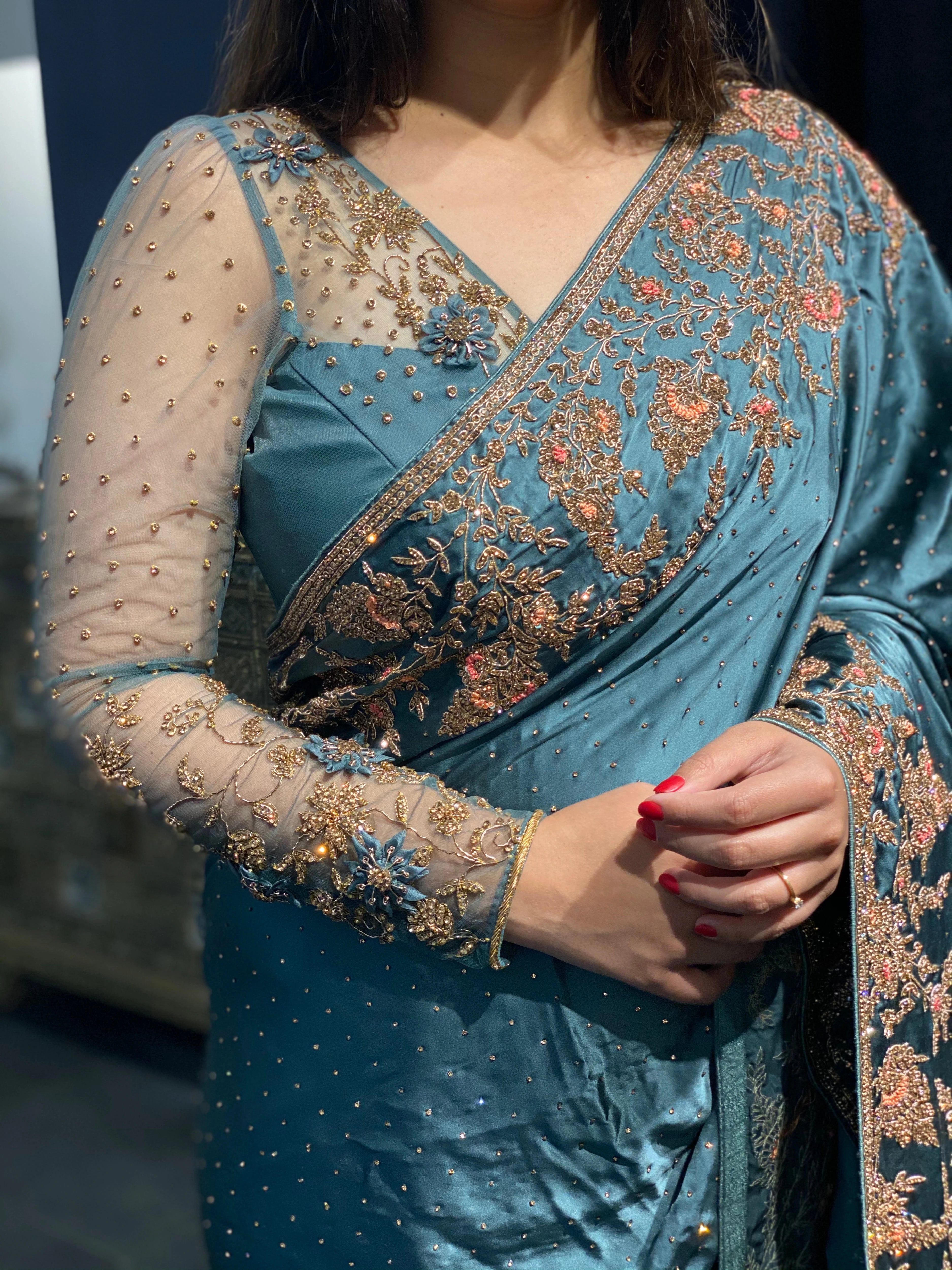 Bride Neha during her fittings in a blue grey tulle blouse handcrafted by team Archana Karthick.