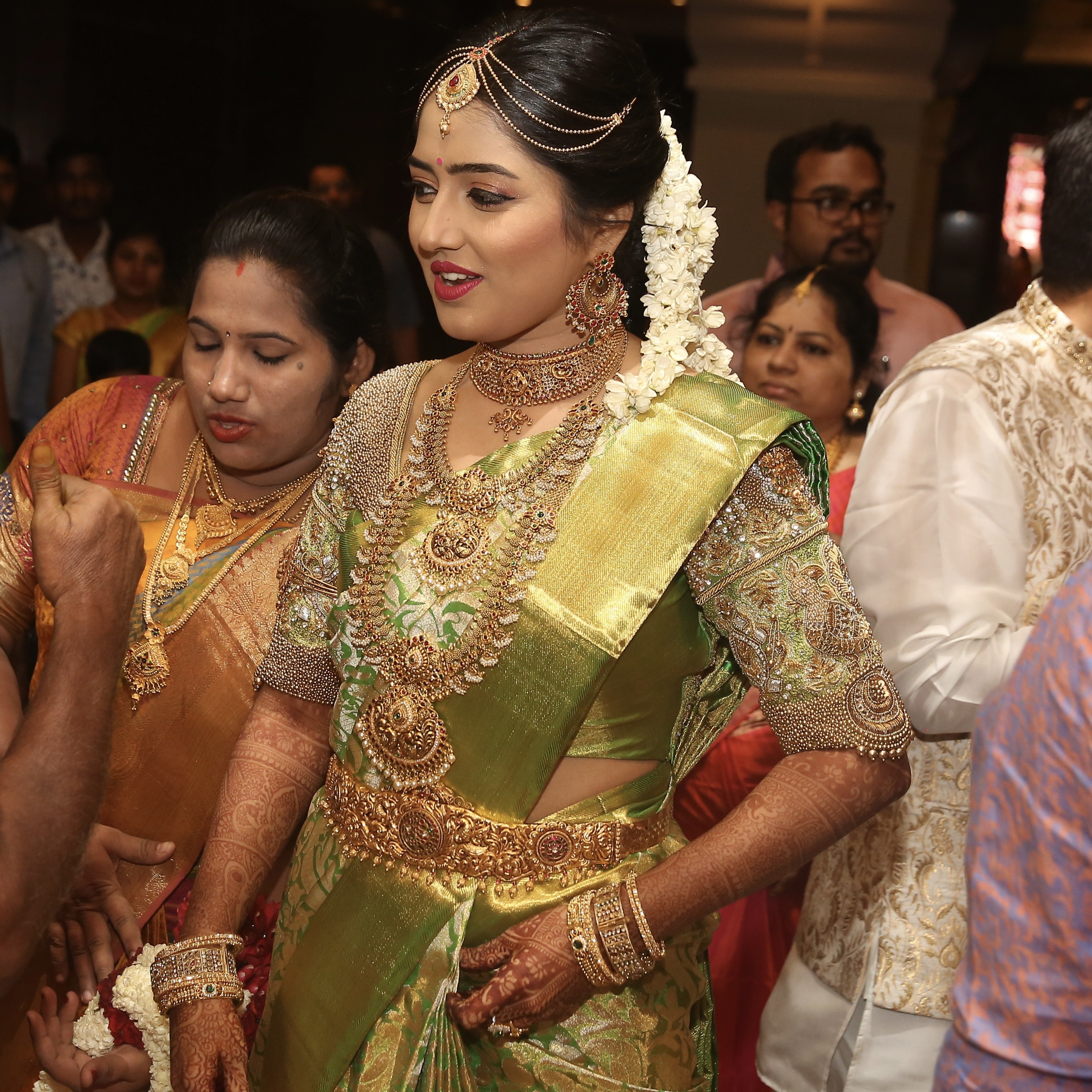 Bride Nivetha in a lemon green silk blouse, intricately handcrafted with zardozi, beads, stones, nakshi and more by team Archana Karthick.