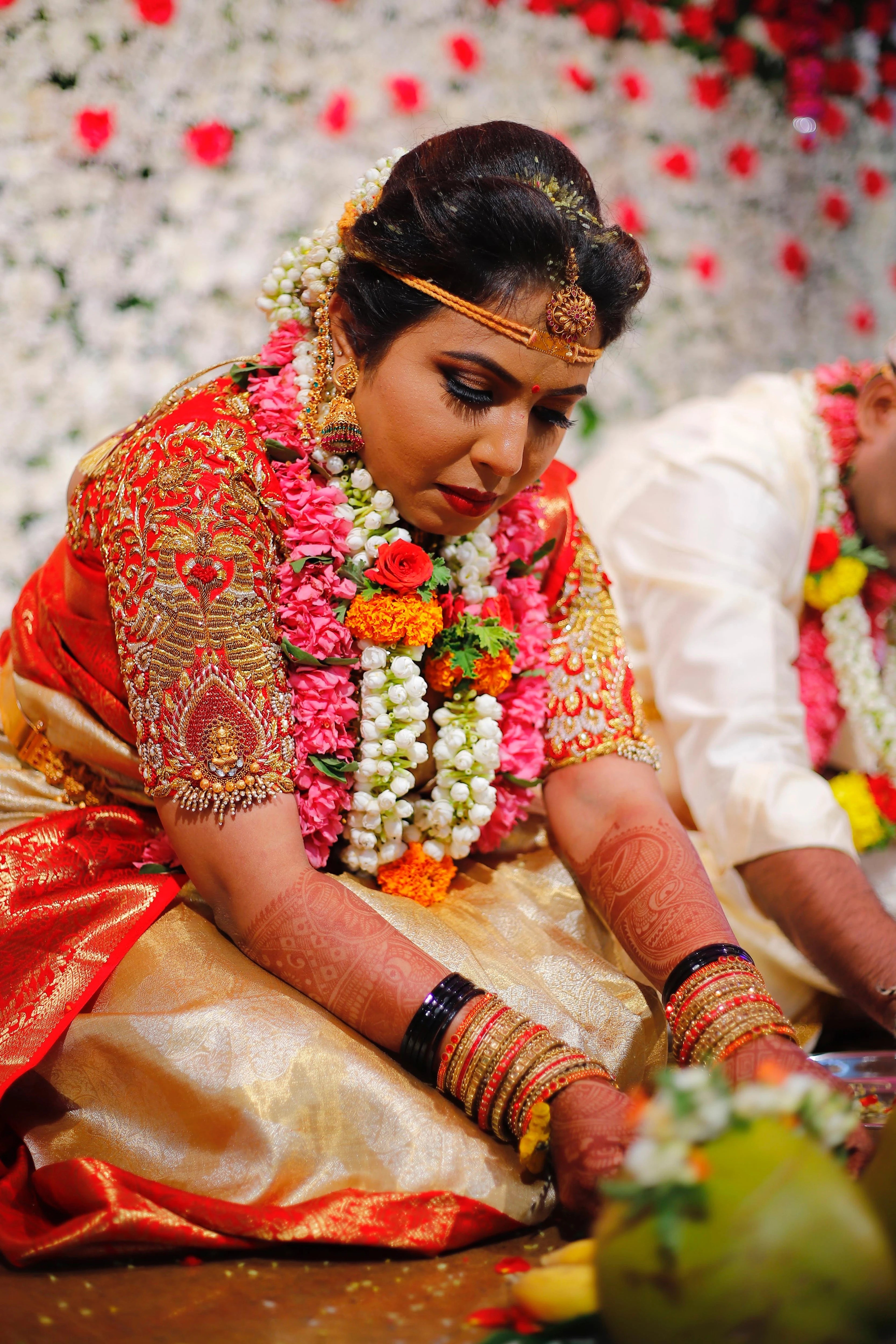 Bride Pooja from Bangalore, during rituals in a red silk blouse handcrafted by team Archana Karthick.
