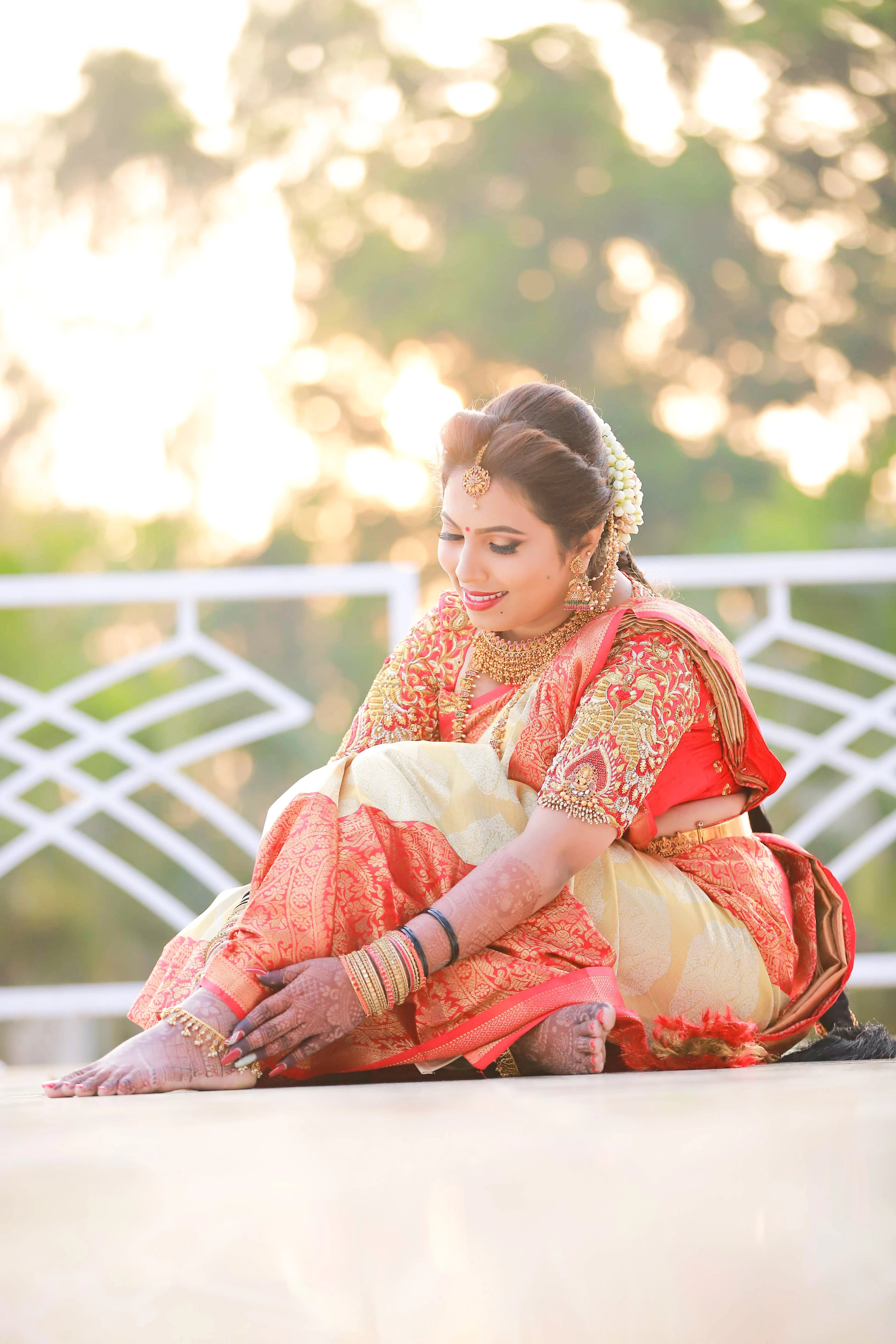 Bride Pooja from Bangalore, posing in a red silk blouse handcrafted by team Archana Karthick.