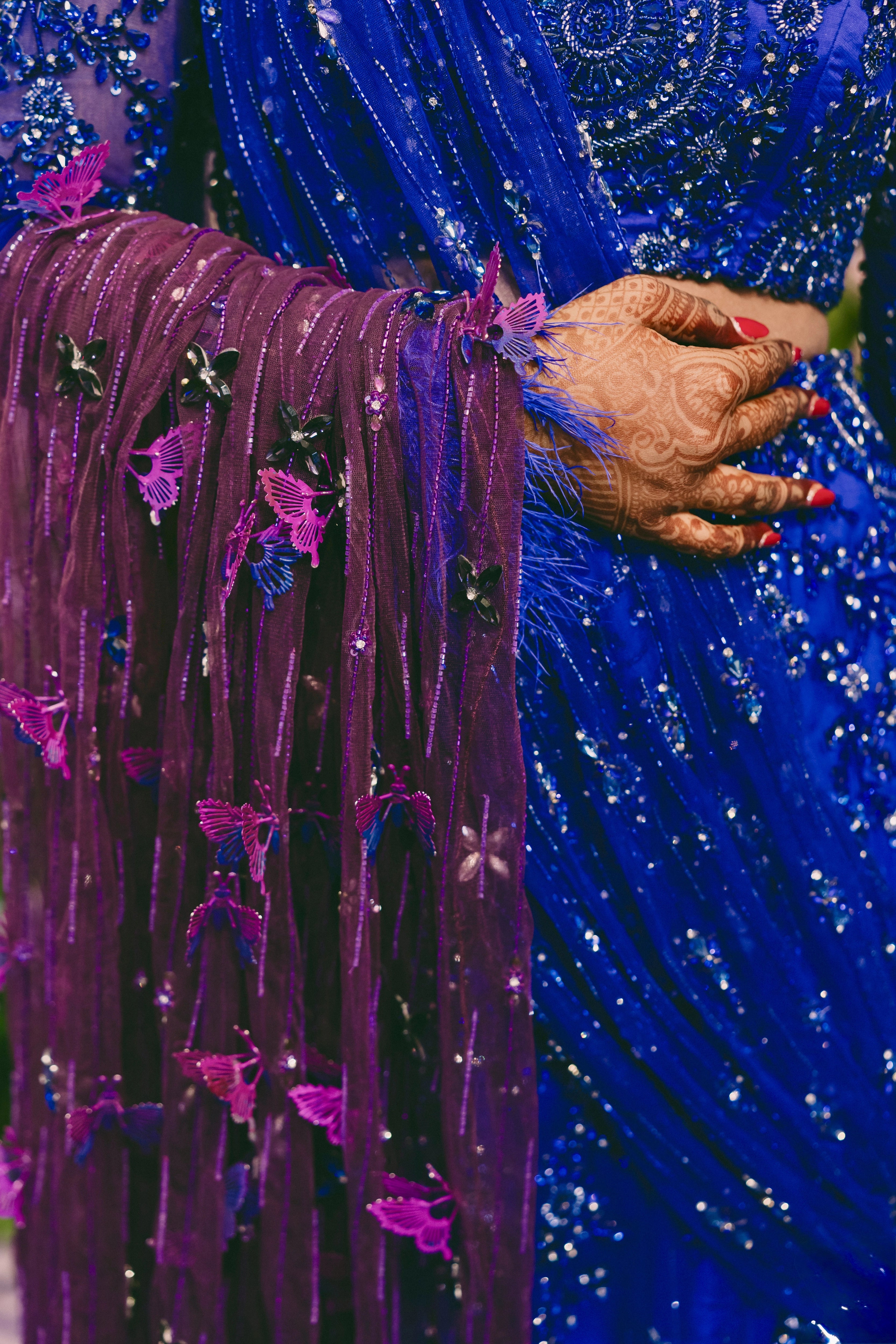 Bride Pooja showcasing handcrafted butterflies in a blue and purple mermaid draped lehenga by team Archana Karthick.