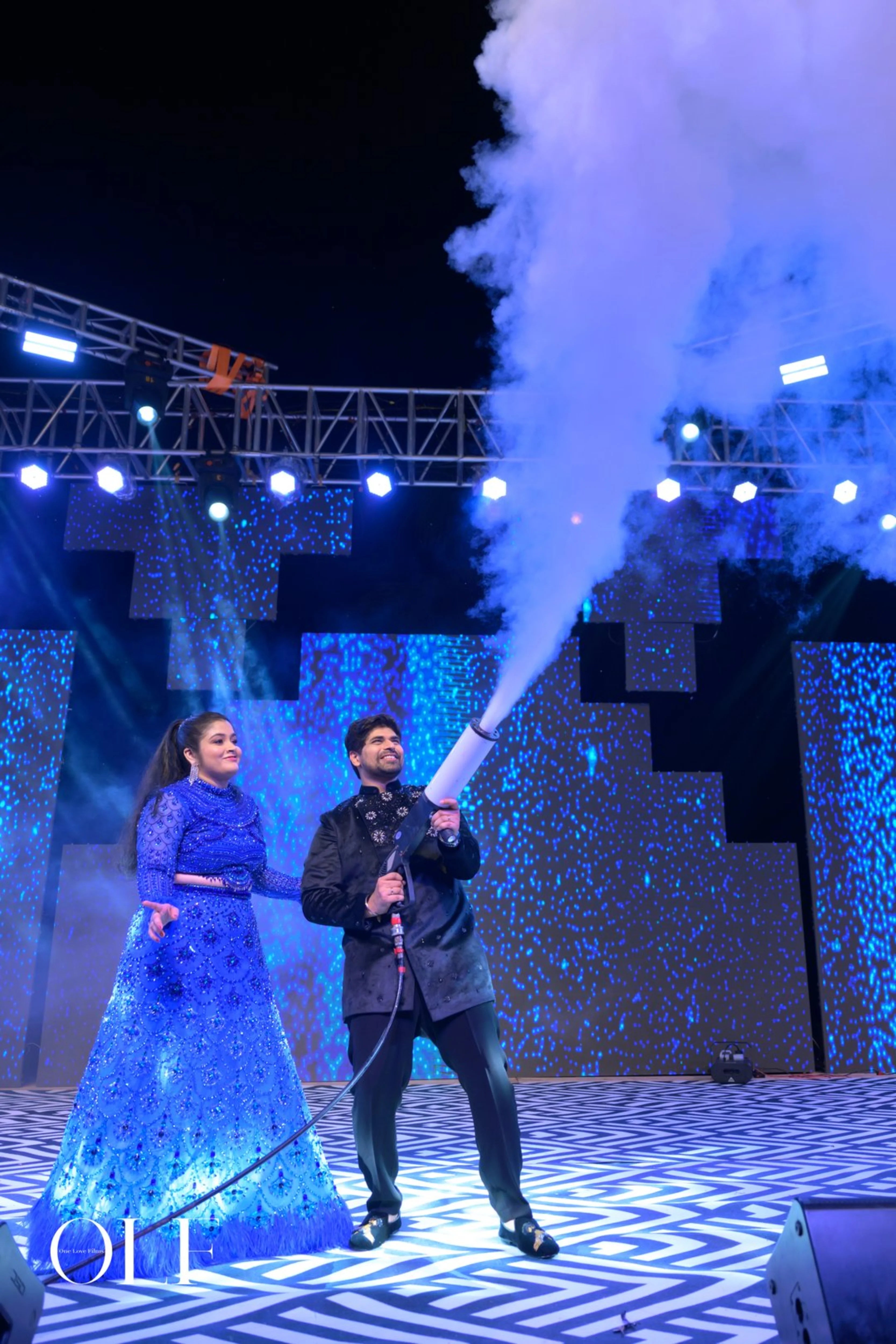 Bride Rasagnya from US with groom in a peacock themed blue tulle lehenga, handcrafted with rhinestones, crystals, cutdana, sequins and feathers by team Archana Karthick.