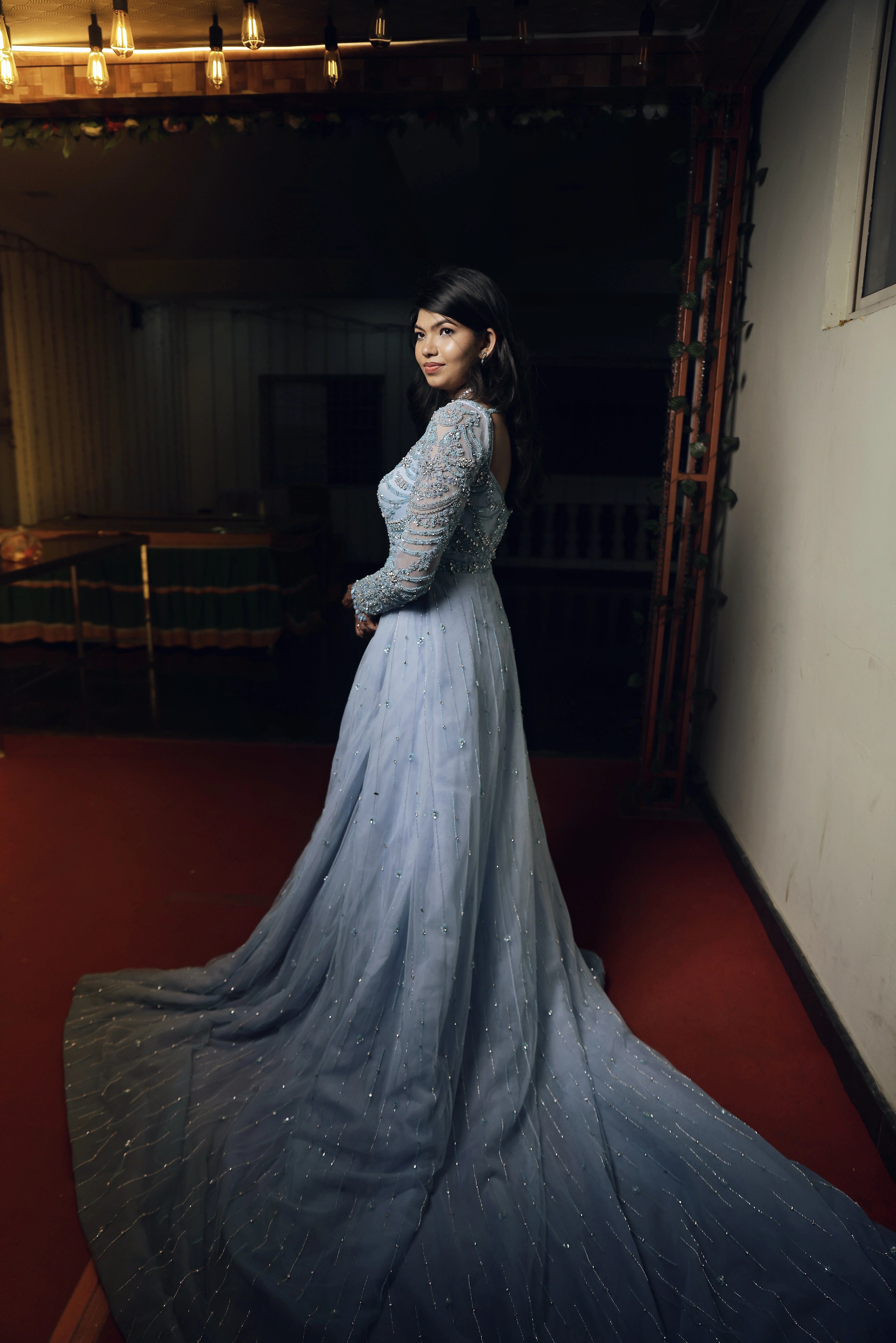 Bride Raxana posing for photoshoot in a blue tulle mermaid gown by team Archana Karthick.