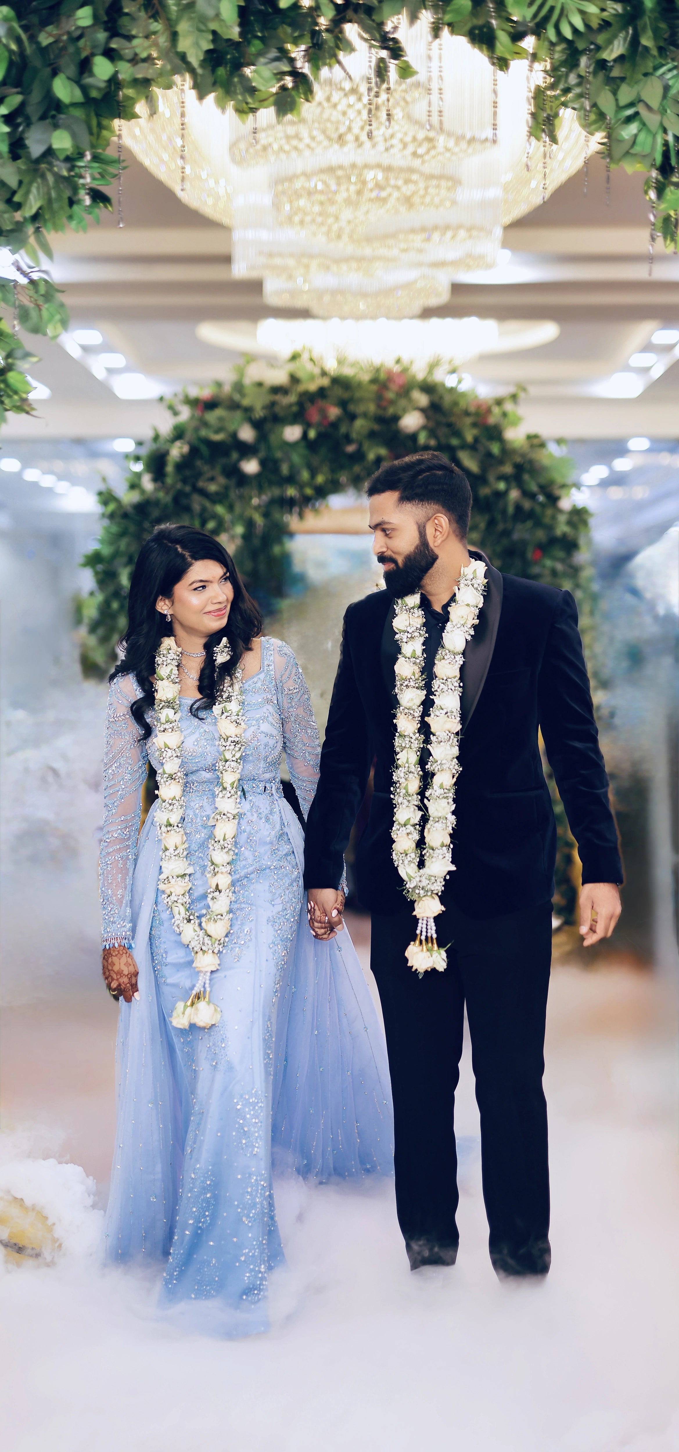 Bride Raxana with groom in a blue tulle mermaid gown by team Archana Karthick.