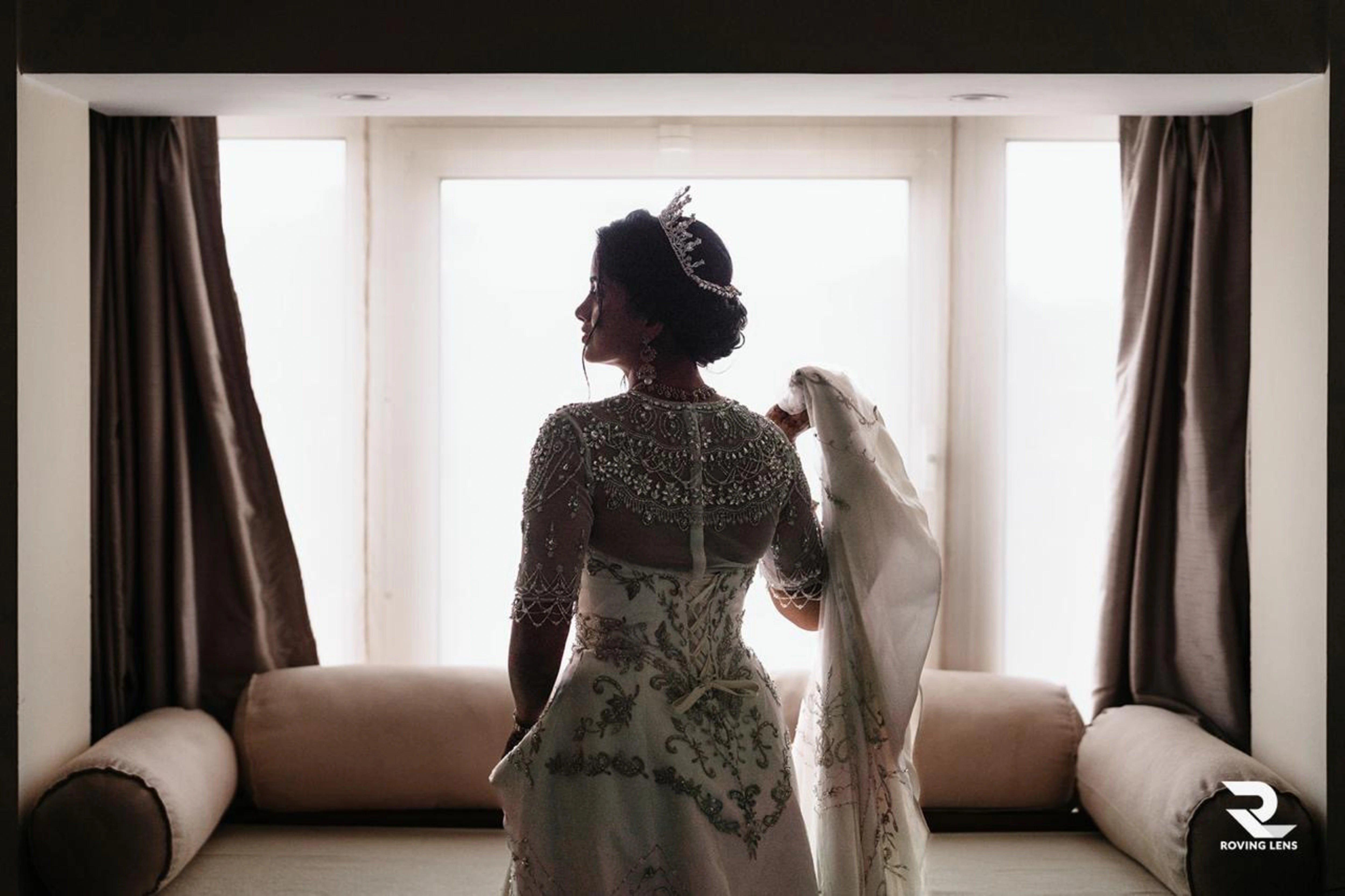 Bride Roushni posing for camera in a white gown for her church wedding by team Archana Karthick.