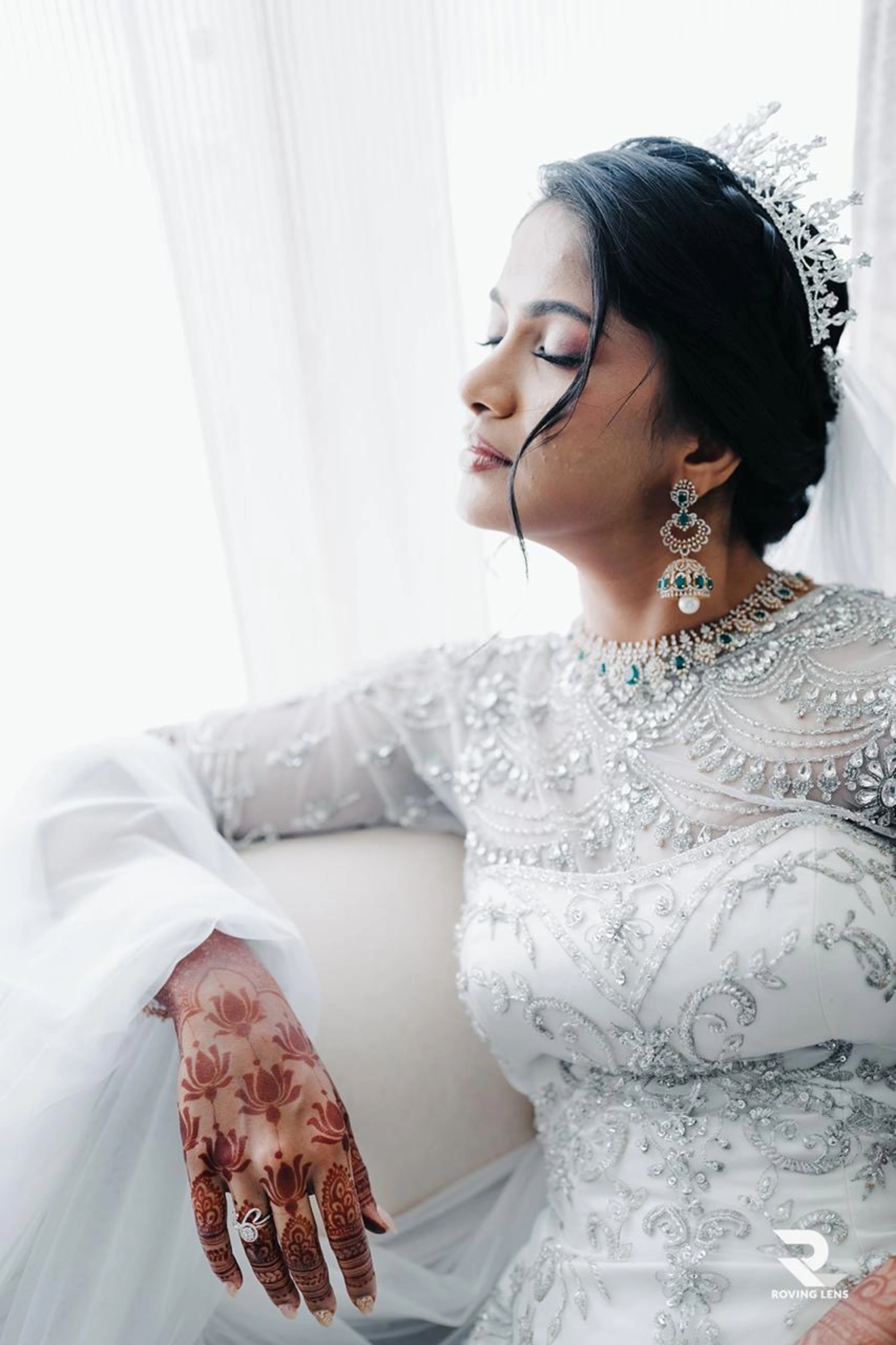 Bride Roushni posing for shoot in a white gown for her church wedding by team Archana Karthick.